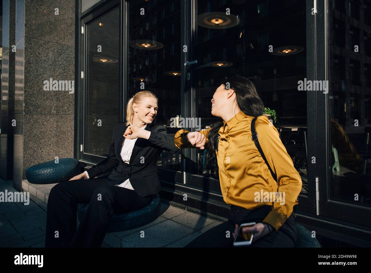 Women greeting using elbows Stock Photo