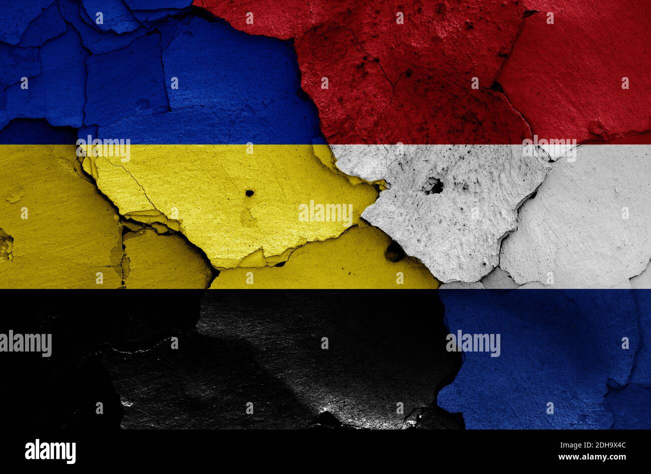 Flags of Gelderland and Netherlands painted on cracked wall Stock Photo