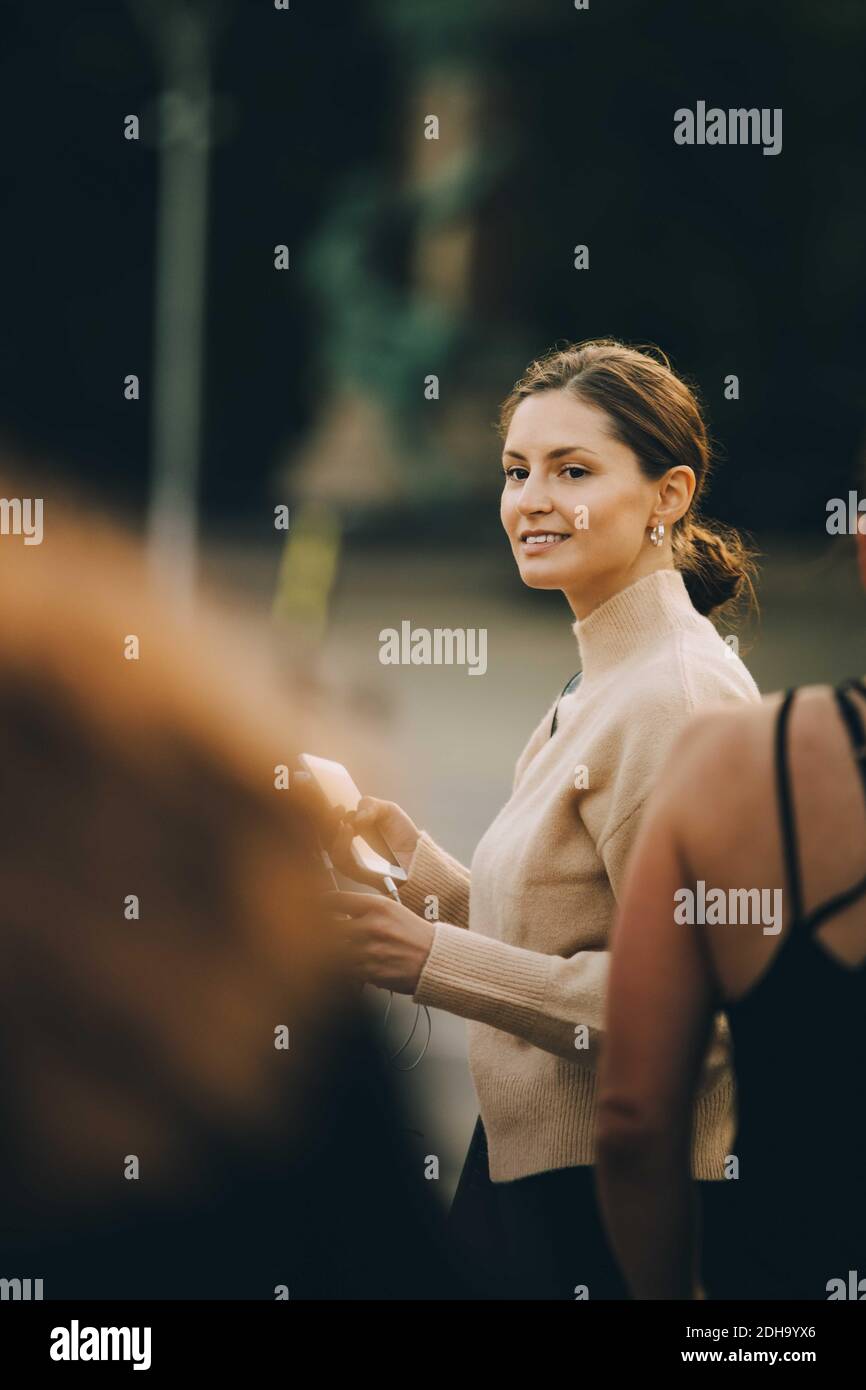 Fashionable woman looking away in city Stock Photo