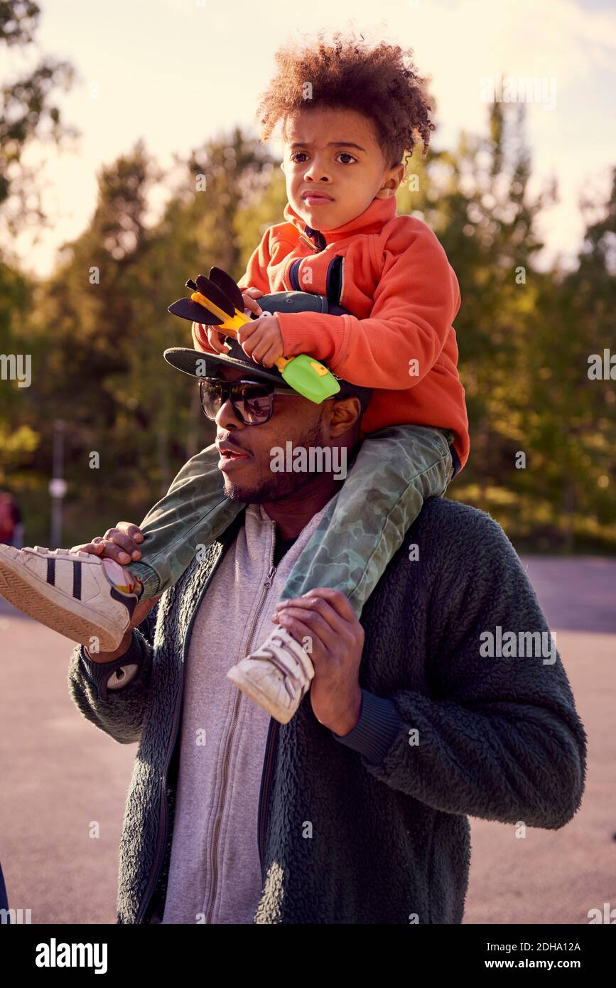 Father carrying boy on shoulders Stock Photo