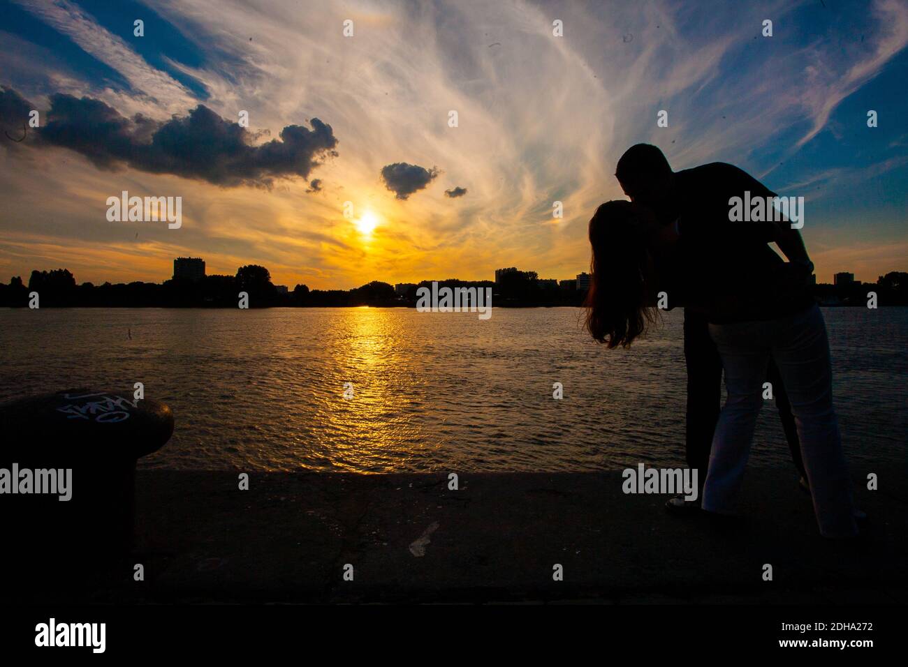 Silhouette of a couple in love during sunset Stock Photo - Alamy