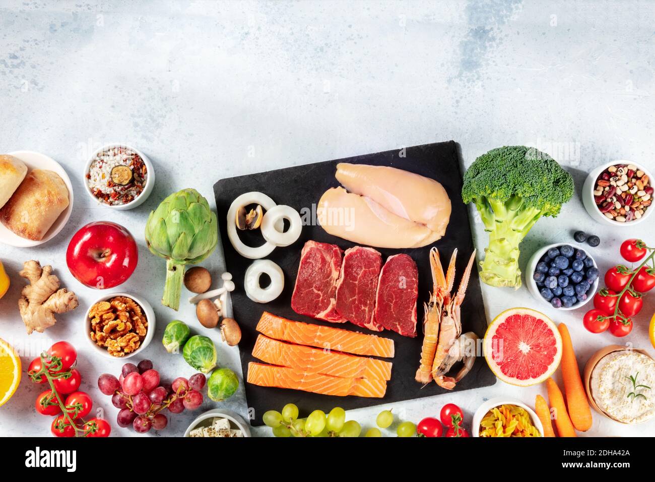 Food. Main proteins, fruit and vegetables, cheeese, nuts, rice, pasta, bread, shot from the top with a place for text Stock Photo