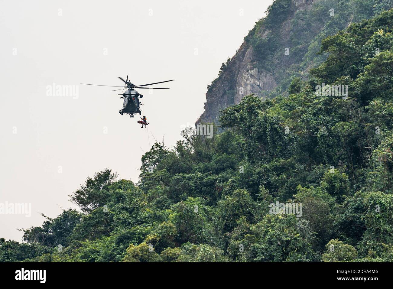 A Hong Kong Government Flying Service Airbus H175 helicopter (Registration: B-LVG) seen during a recue mission to provide medical assistant to an injured rock climber who has fallen off the cliff at Central Crag. Stock Photo