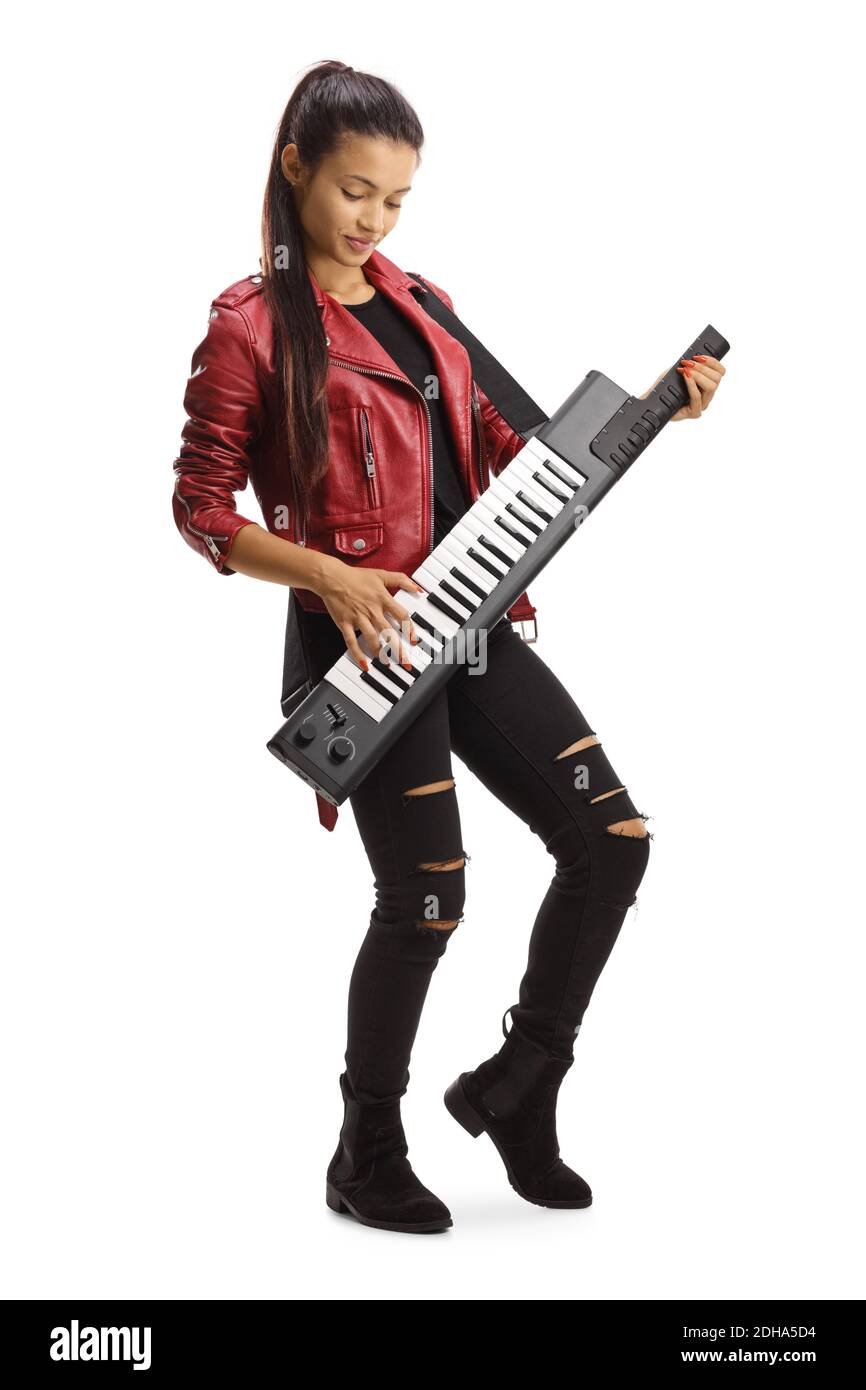 Cute young female in a leather jacket playing a keytar isolated on white background Stock Photo