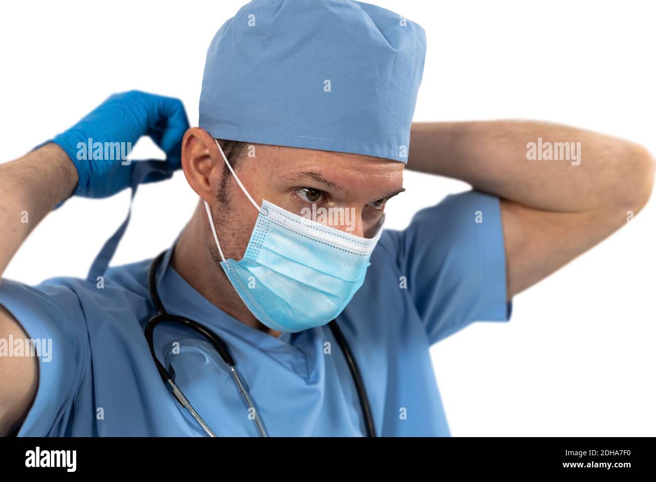 Male surgeon wearing face mask against white background Stock Photo - Alamy