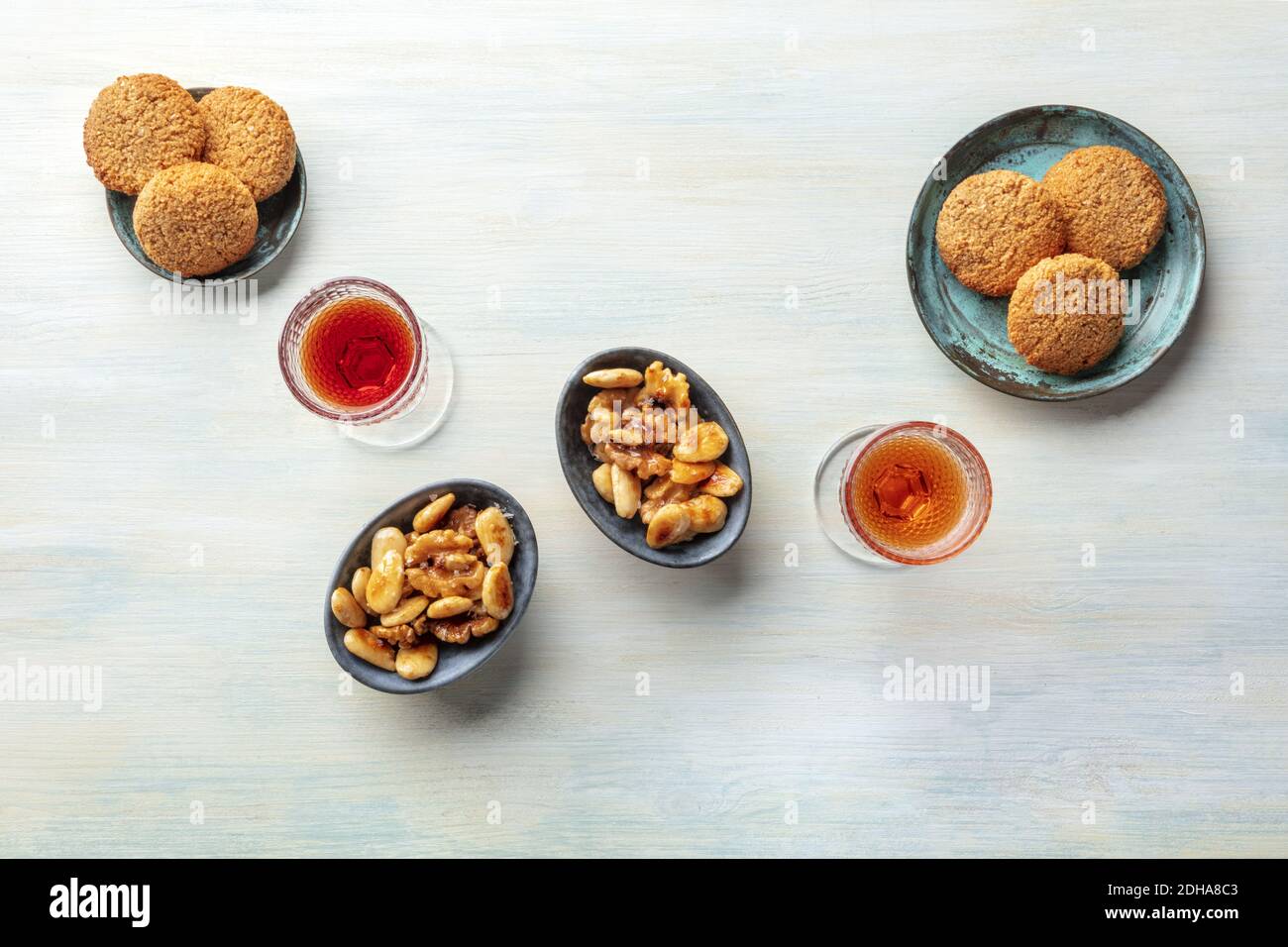 A photo of two glasses of sweet wine with cookies and nuts, shot from the top Stock Photo