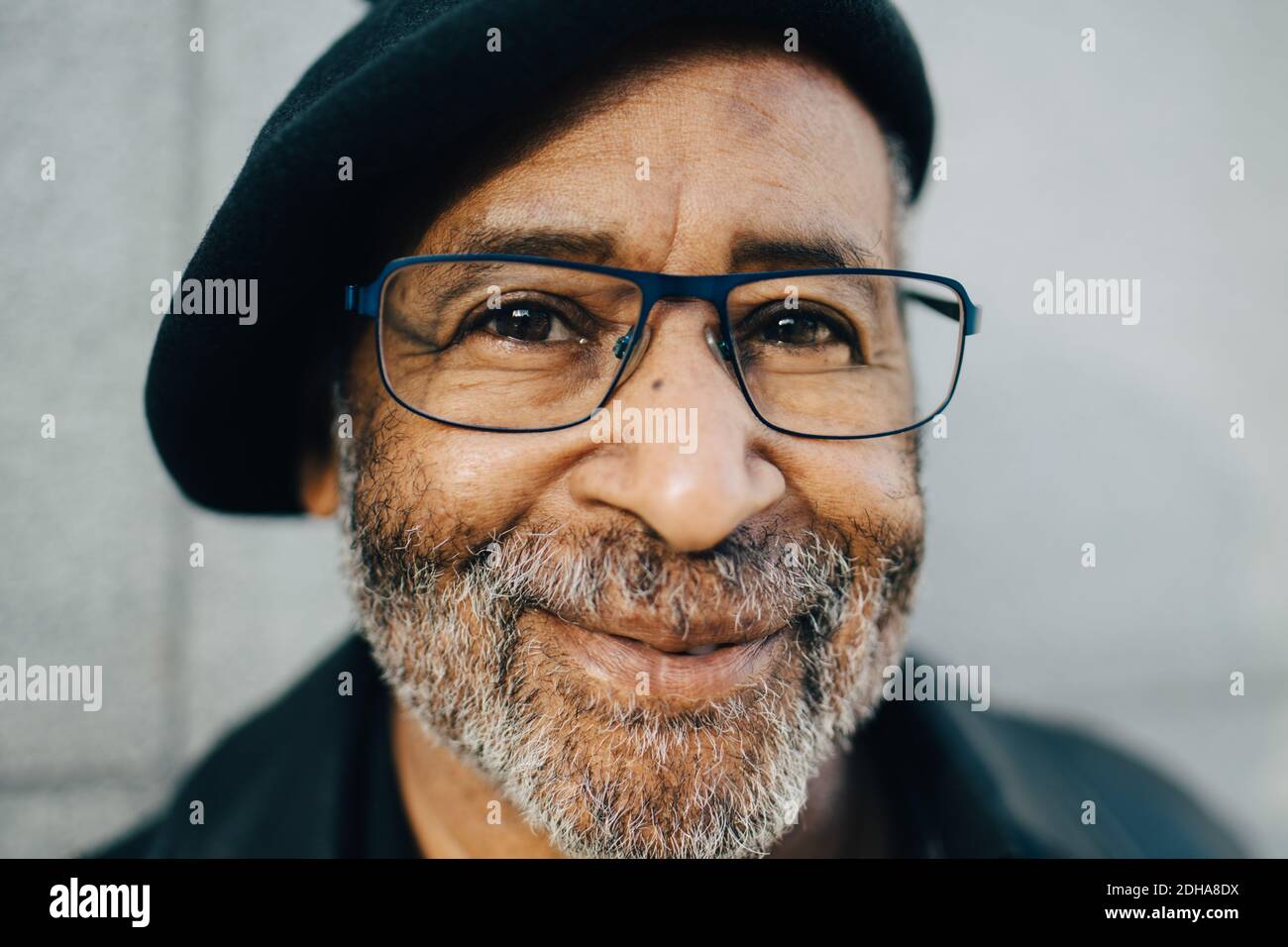 Portrait of senior man against wall Stock Photo