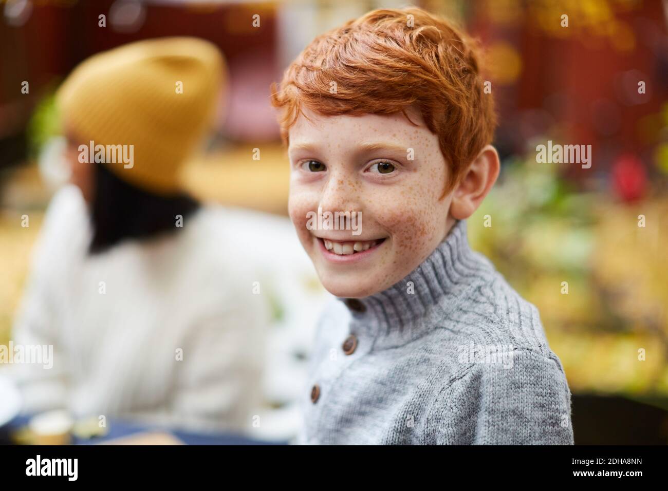 Portrait of smiling boy sitting at yard Stock Photo