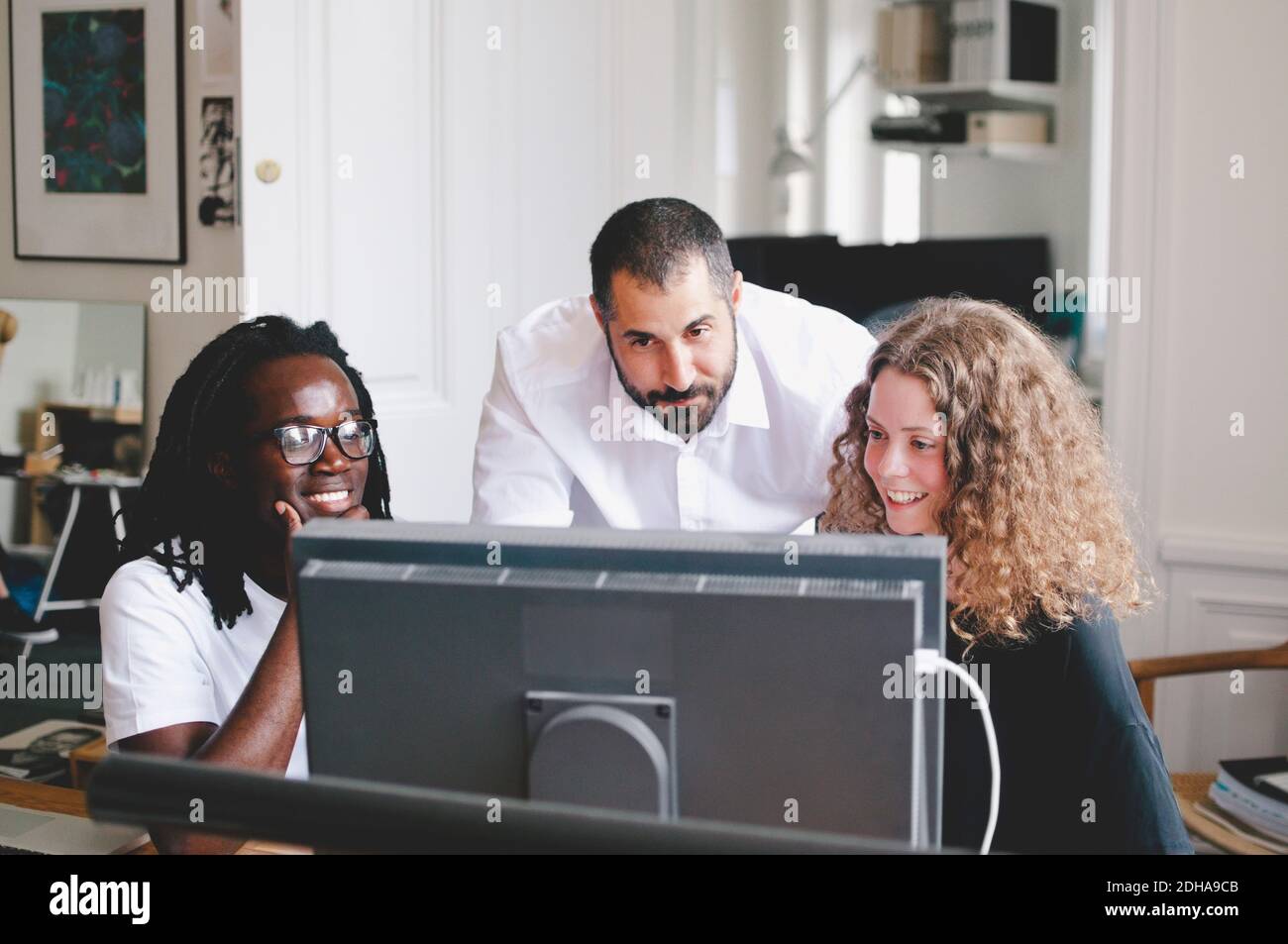 Multi-ethnic business people using computer in creative office Stock Photo