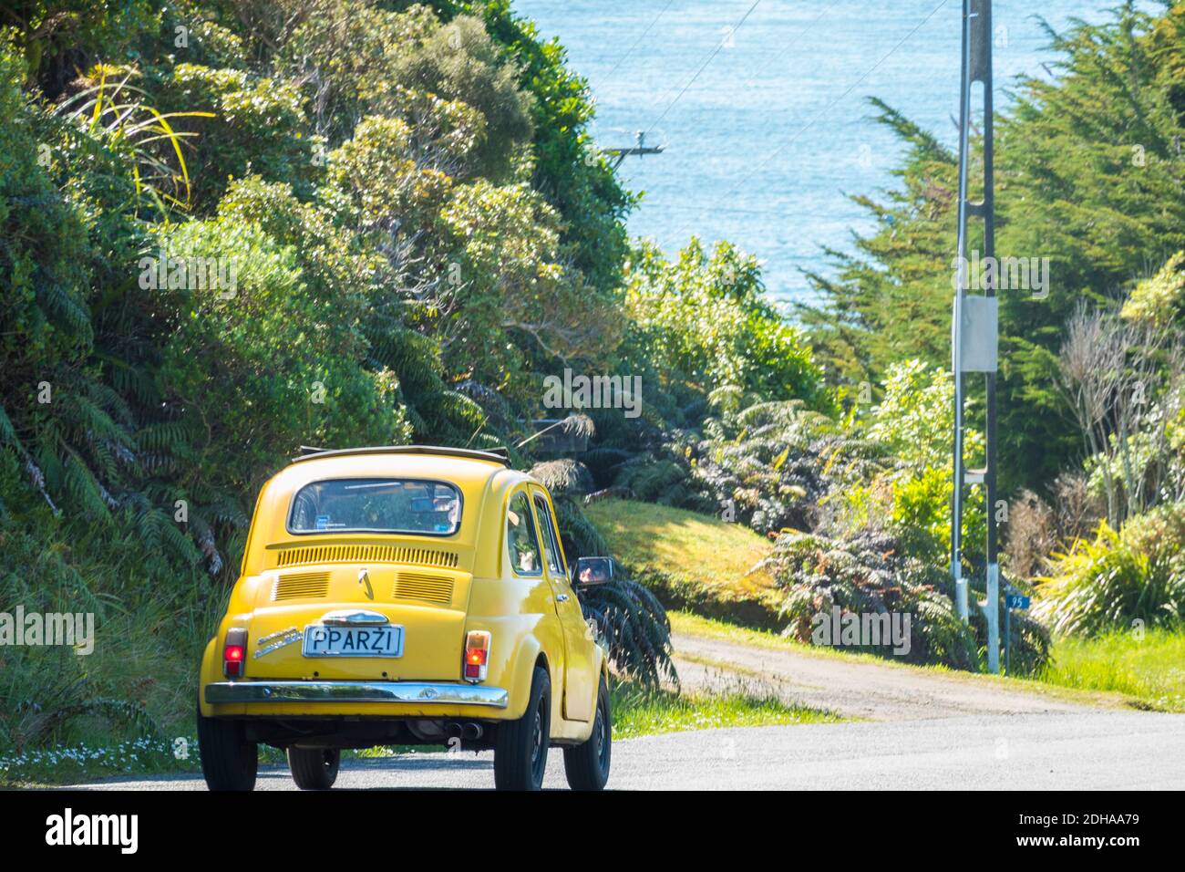 Oban New Zealand - November 3 2020; Bright yellow quirky Fiat Bambina driving past on road Stock Photo