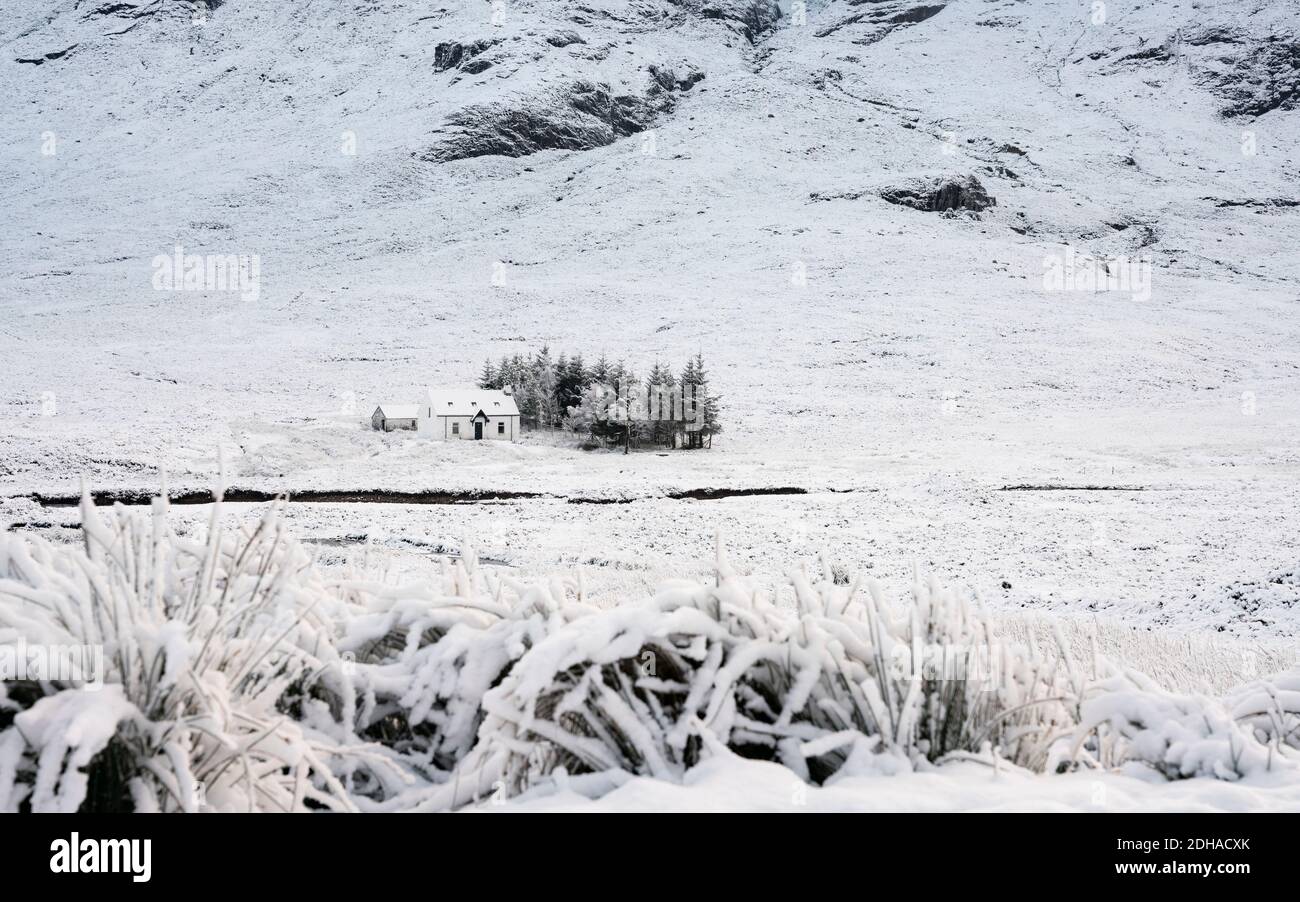 Snow covered winter landscape and cottage in Glen Coe in Scottish Highlands, Scotland, UK Stock Photo