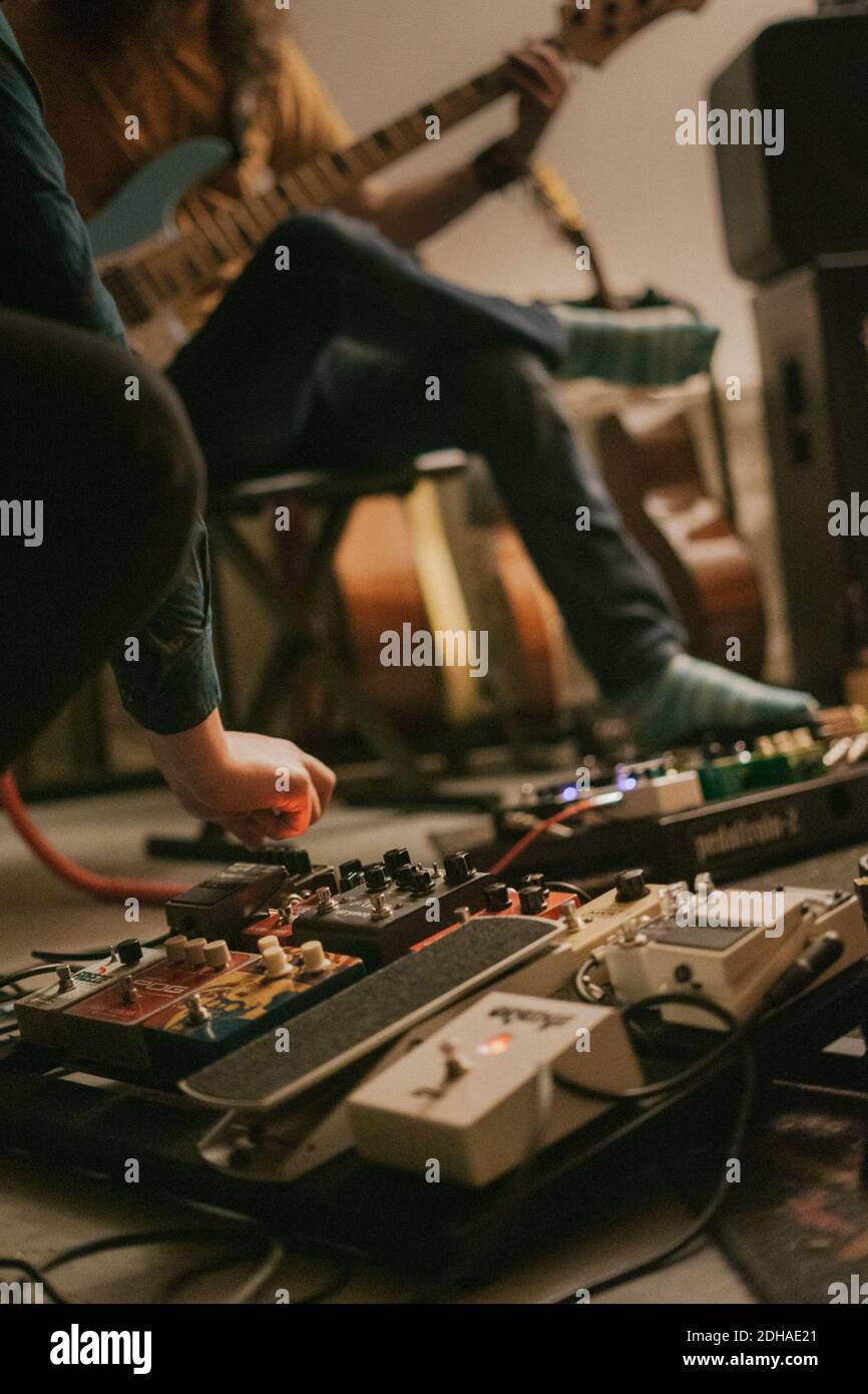 Changing settings on electric guitar pedalboard Stock Photo Alamy