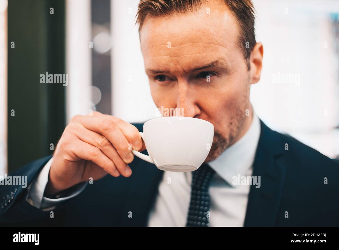 Mature businessman drinking coffee in cafe Stock Photo