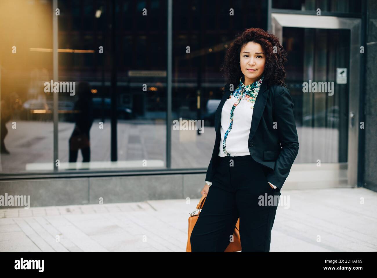 Portrait of confident businesswoman standing against building in city Stock Photo