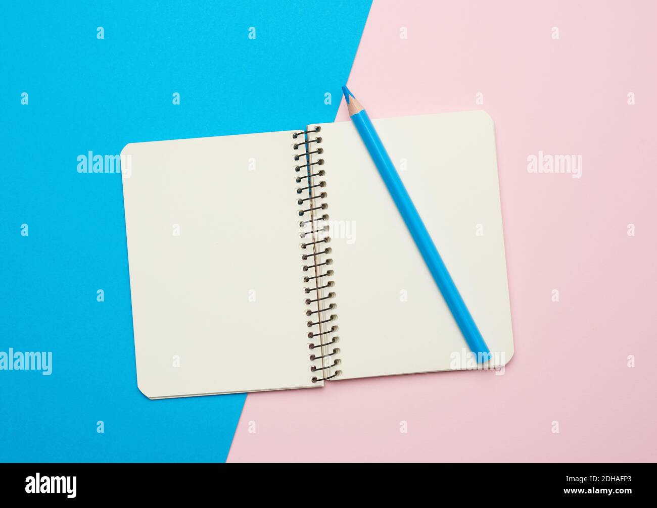Open notepad with empty white sheets on a blue background Stock Photo