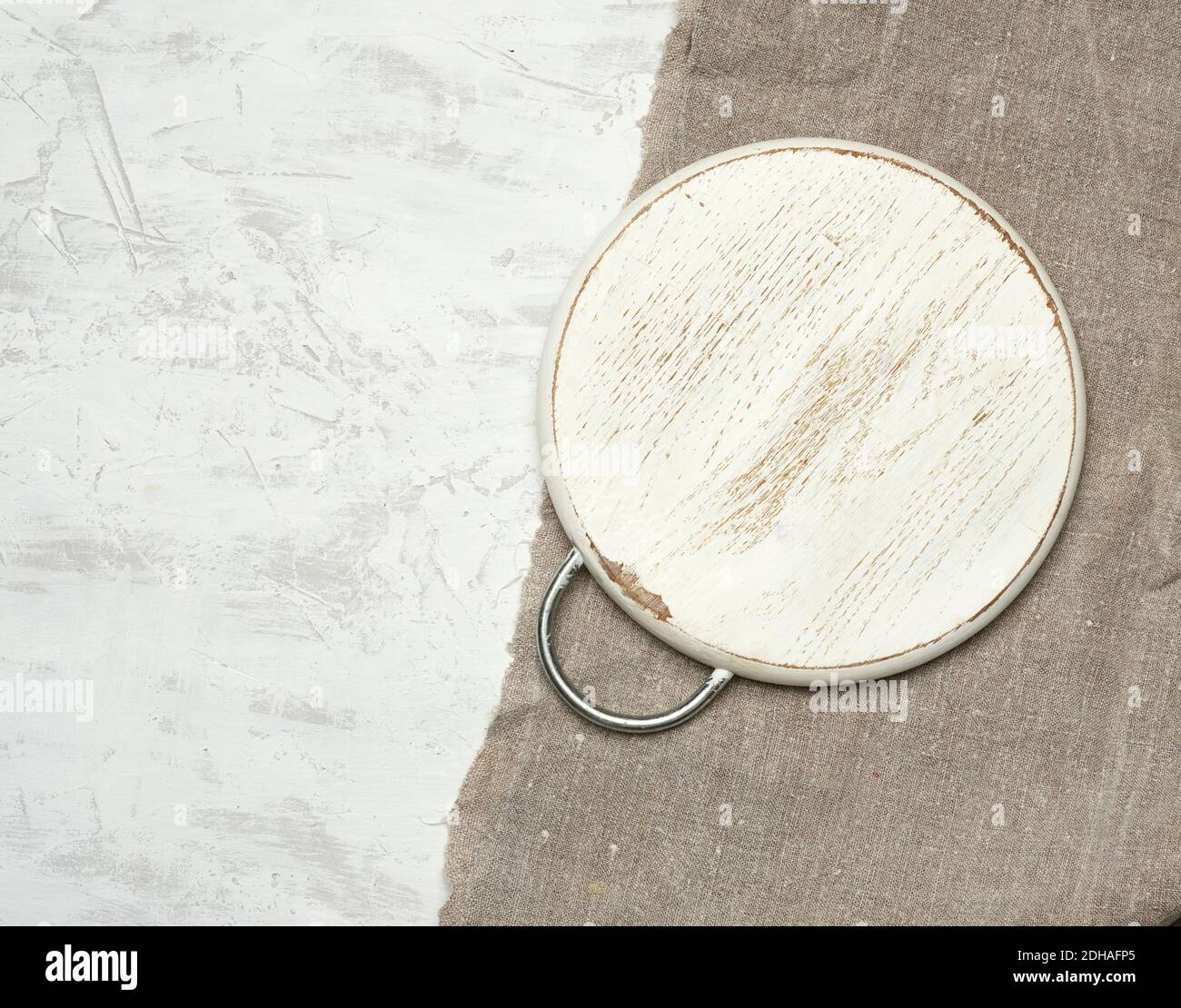 Empty round small cutting board lie on a white background Stock Photo