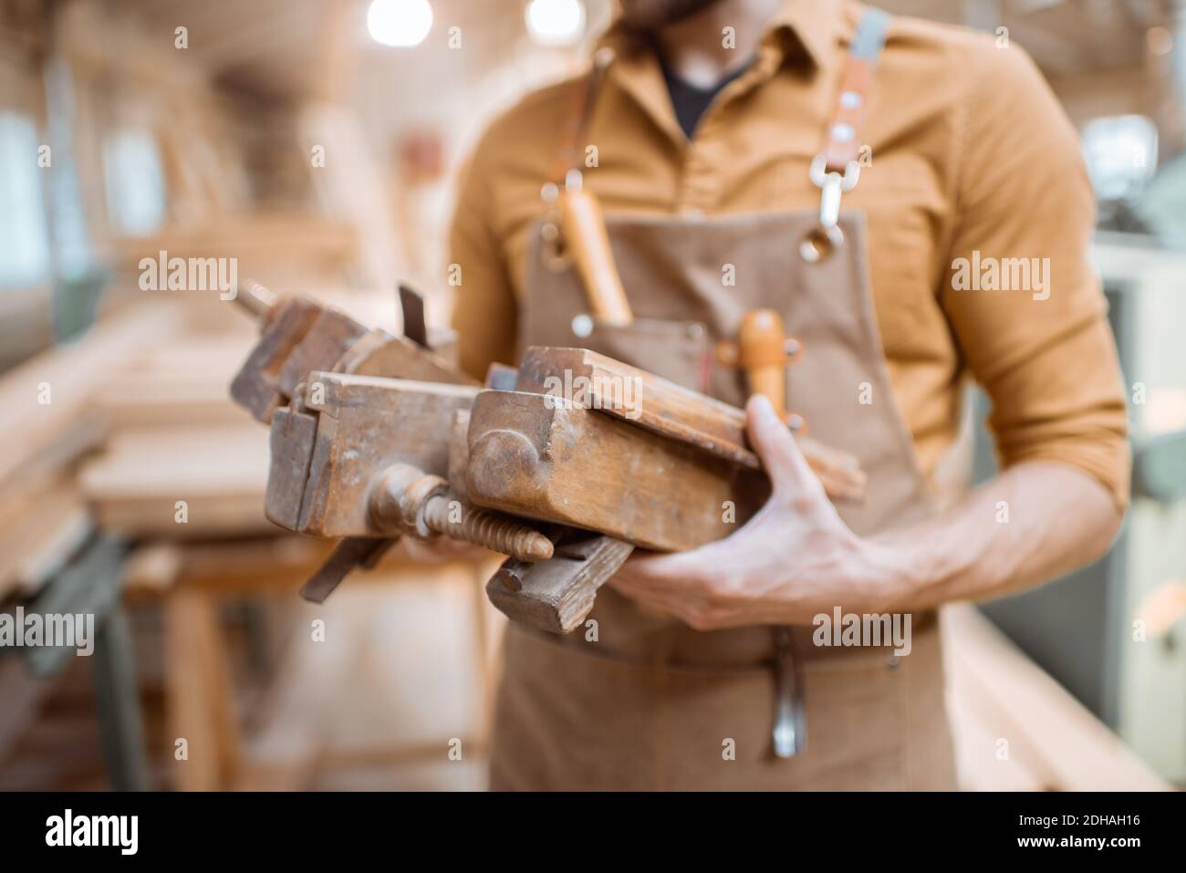 Handsome carpenter with vintage working tools in the carpentry workshop Stock Photo
