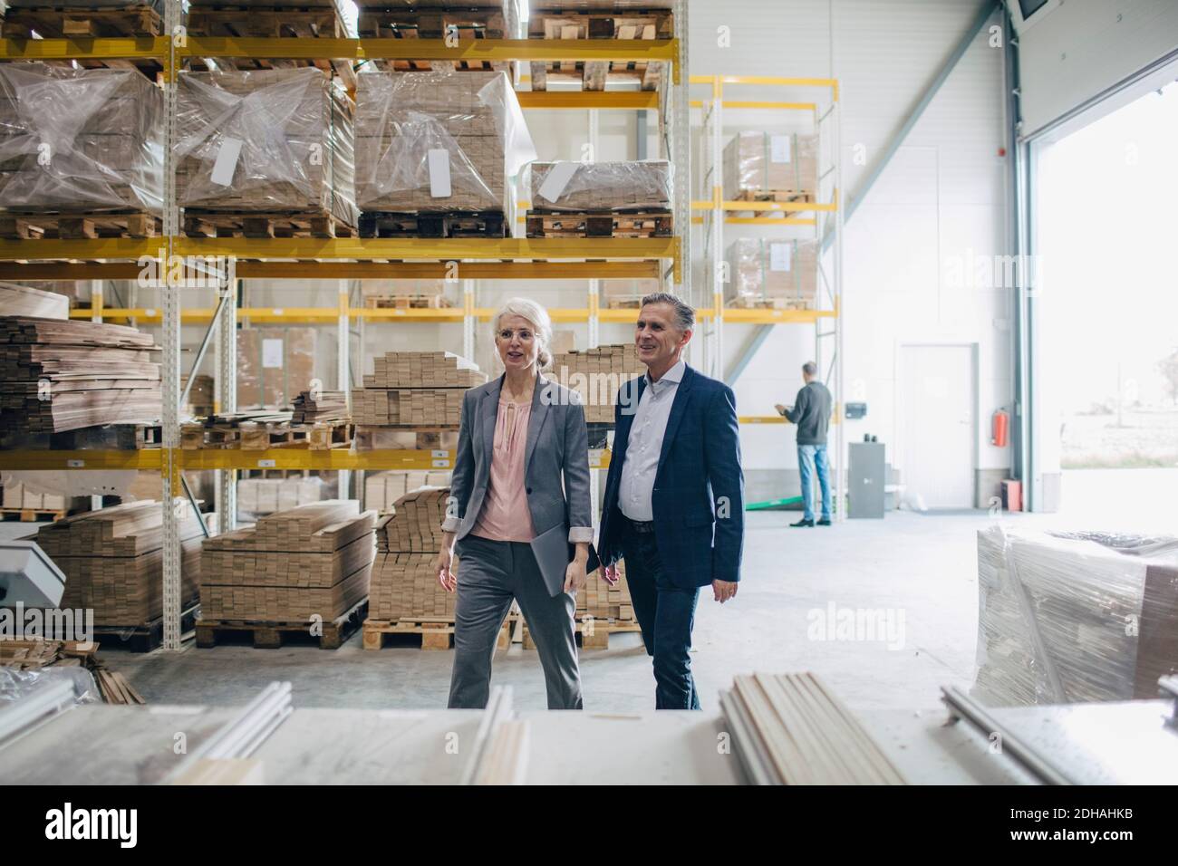 Business people walking by wooden planks at industry Stock Photo