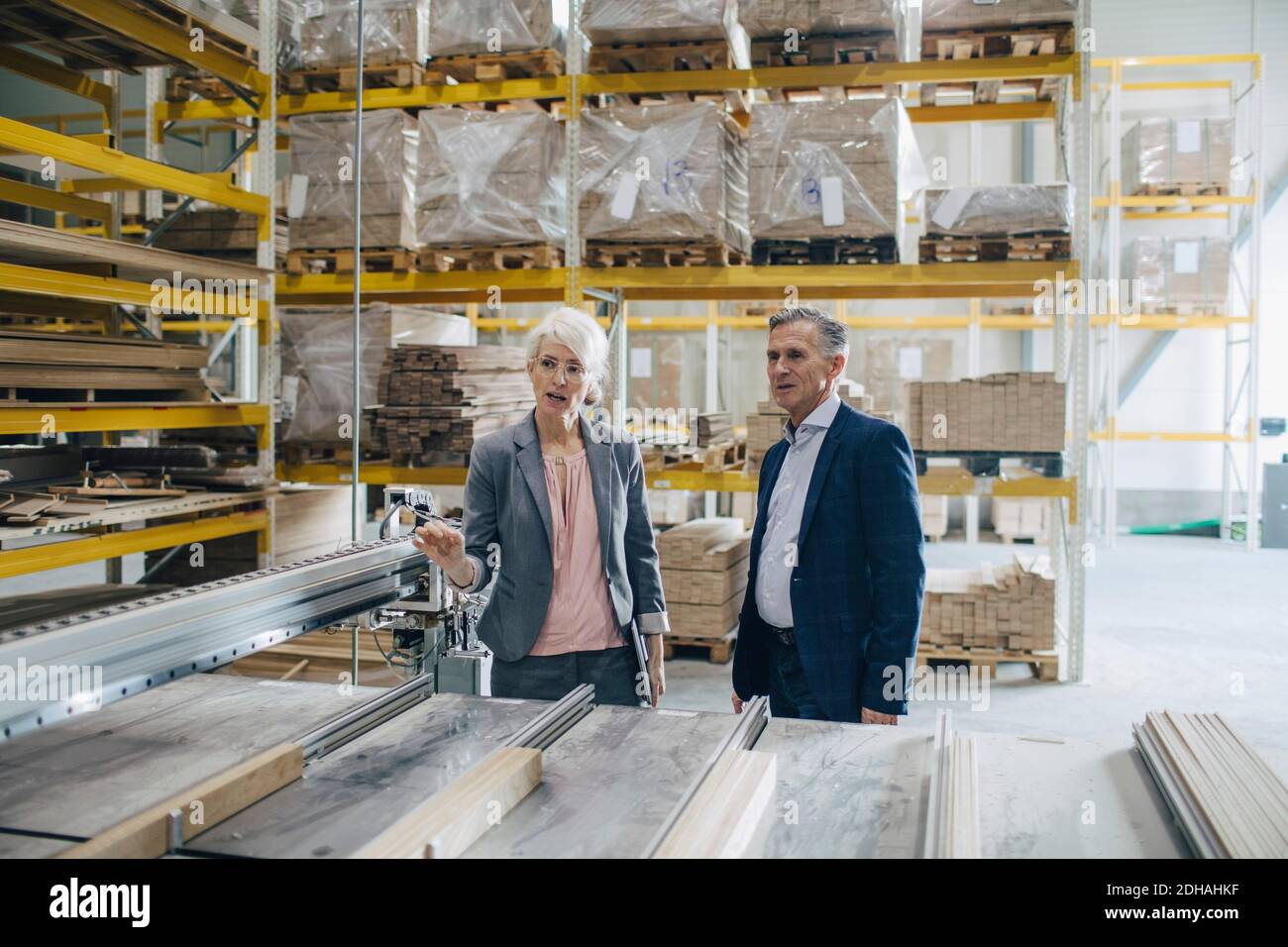 Business people analyzing wooden planks at industry Stock Photo