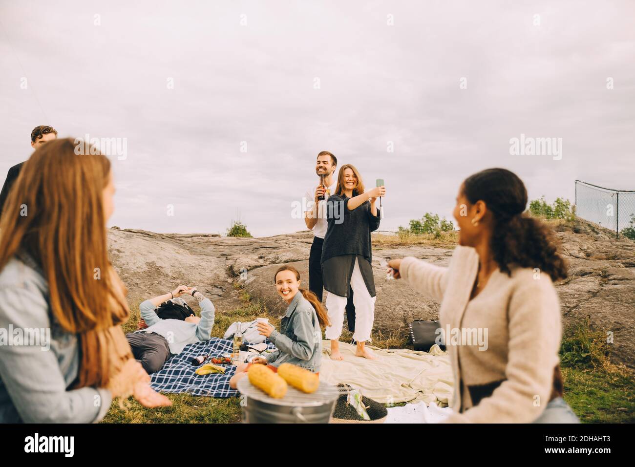 Friends hanging out, enjoying picnic - Stock Image - F020/2364 - Science  Photo Library