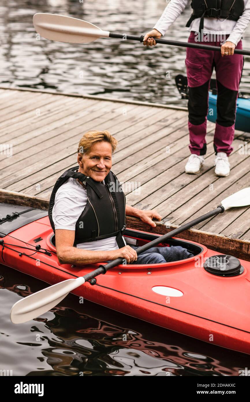 Portrait of smiling senior man sitting in kayak during kayaking course Stock Photo