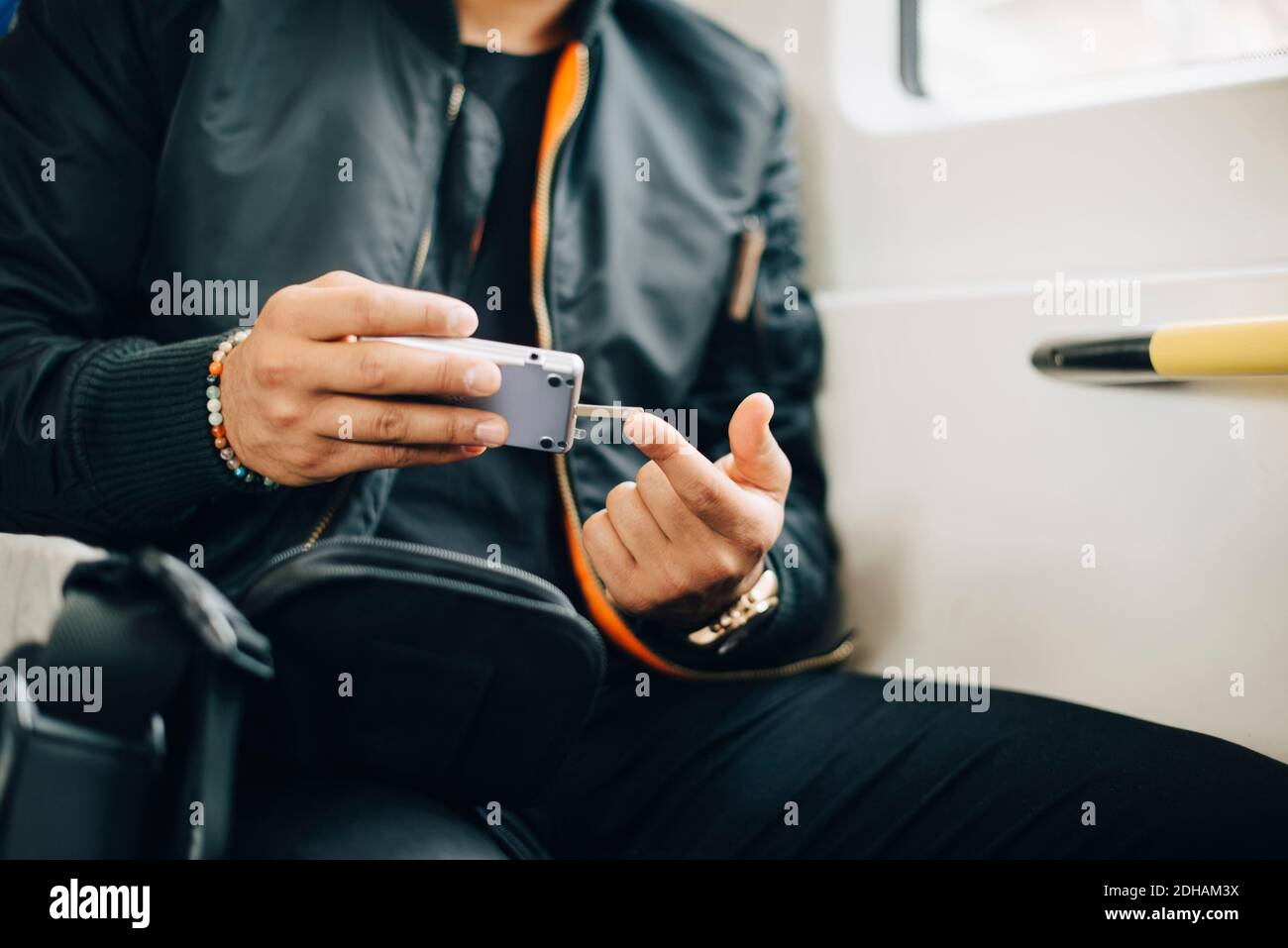 Man doing blood test with glaucometer while sitting in train Stock Photo