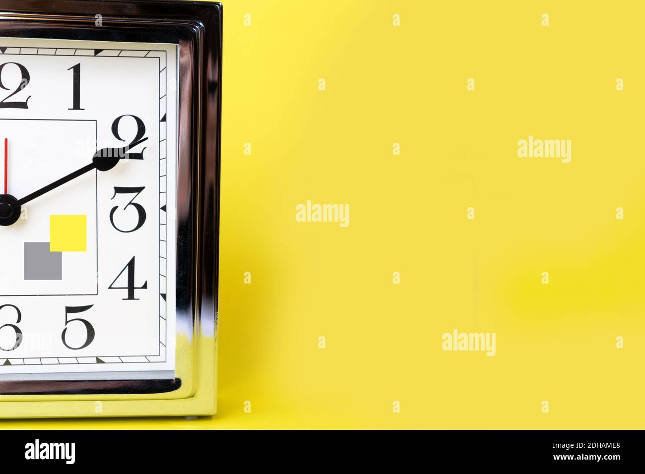 Color of the 2021 time concept with metal gold alarm clock and bright illuminating yellow and gray colours background. Shopping. Sale concept. Place for text.  Stock Photo