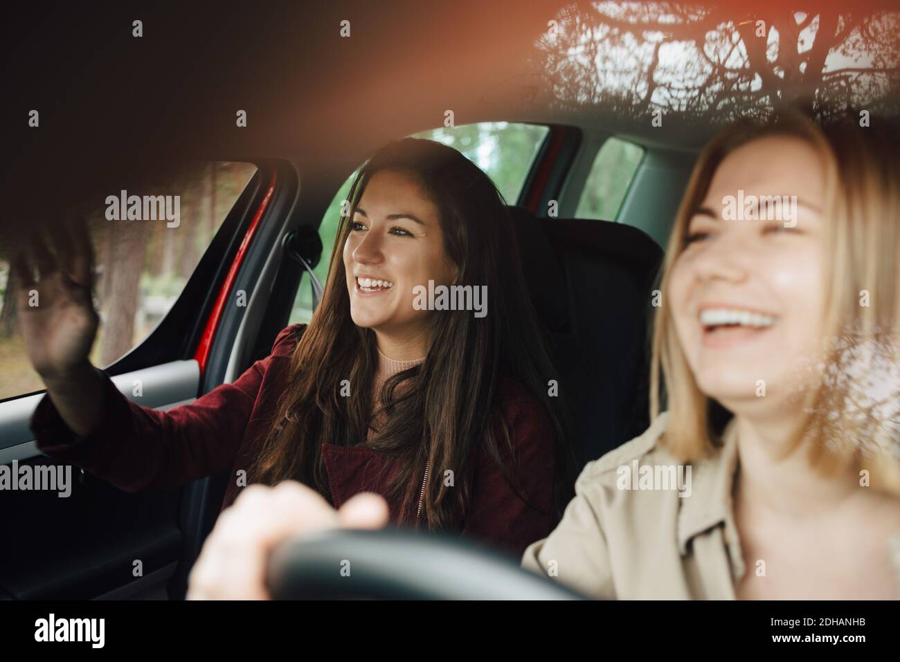 Happy female friends traveling together in car Stock Photo