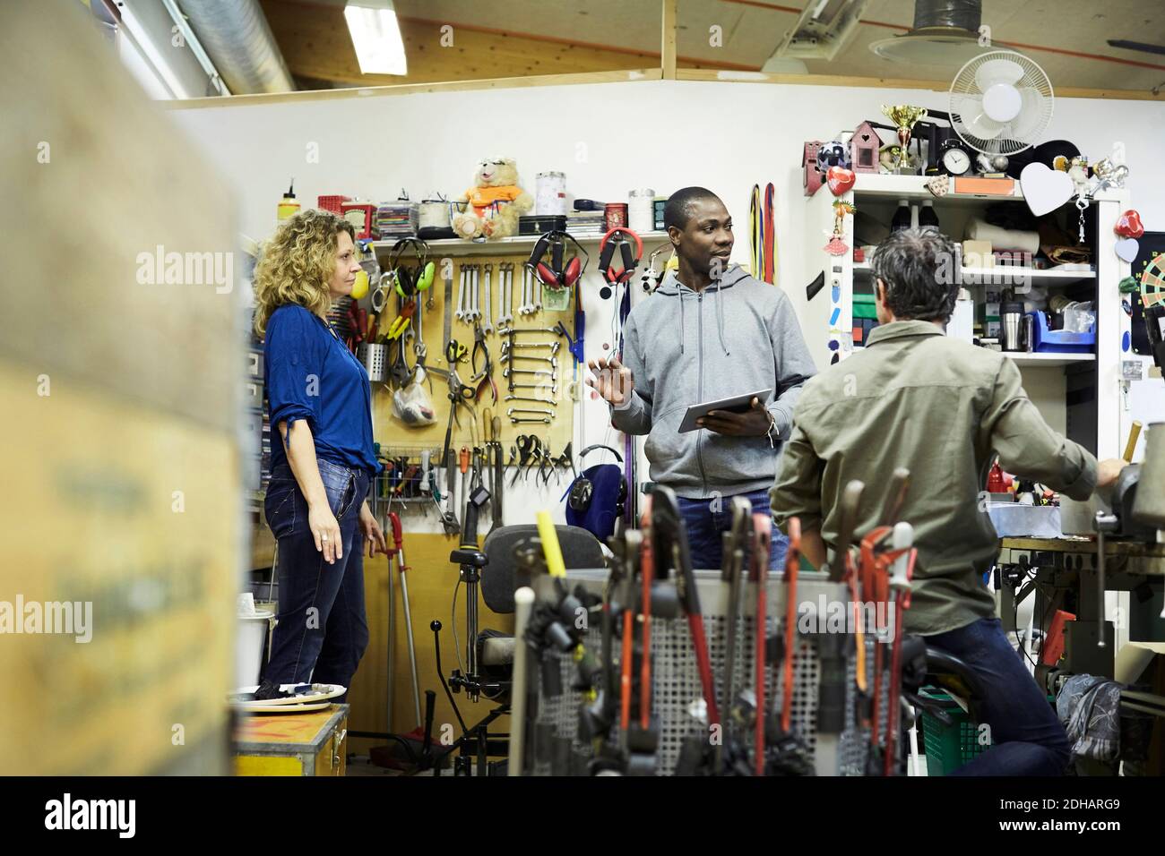 Multi-ethnic coworkers discussing at workshop Stock Photo