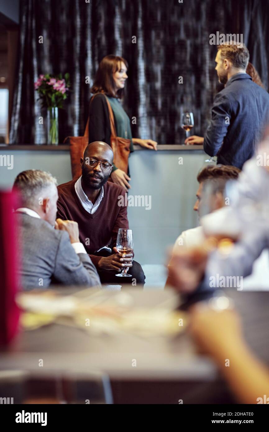 Business executives discussing while having drinks during conference in office Stock Photo