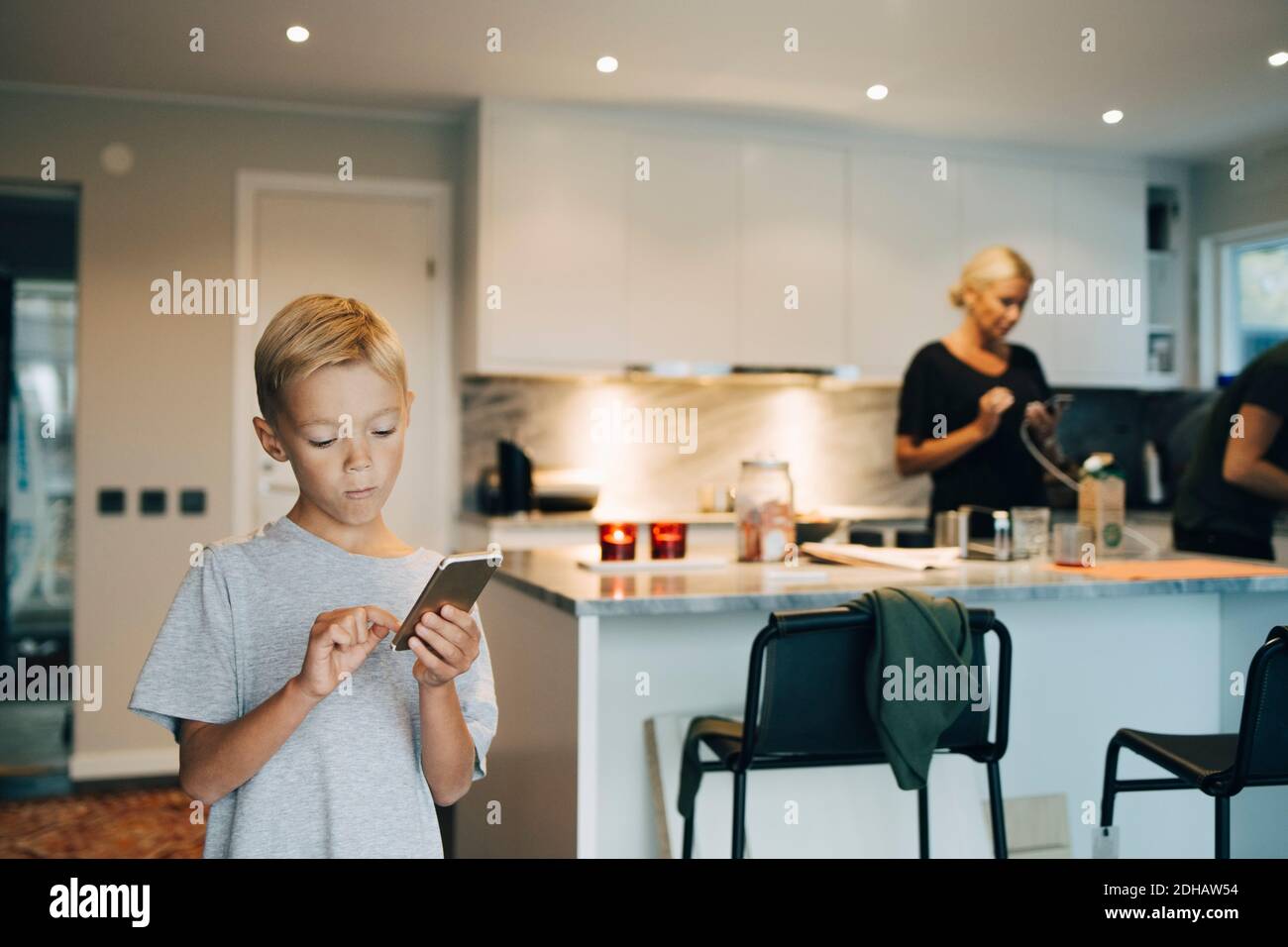 Boy standing on chair hi-res stock photography and images - Alamy