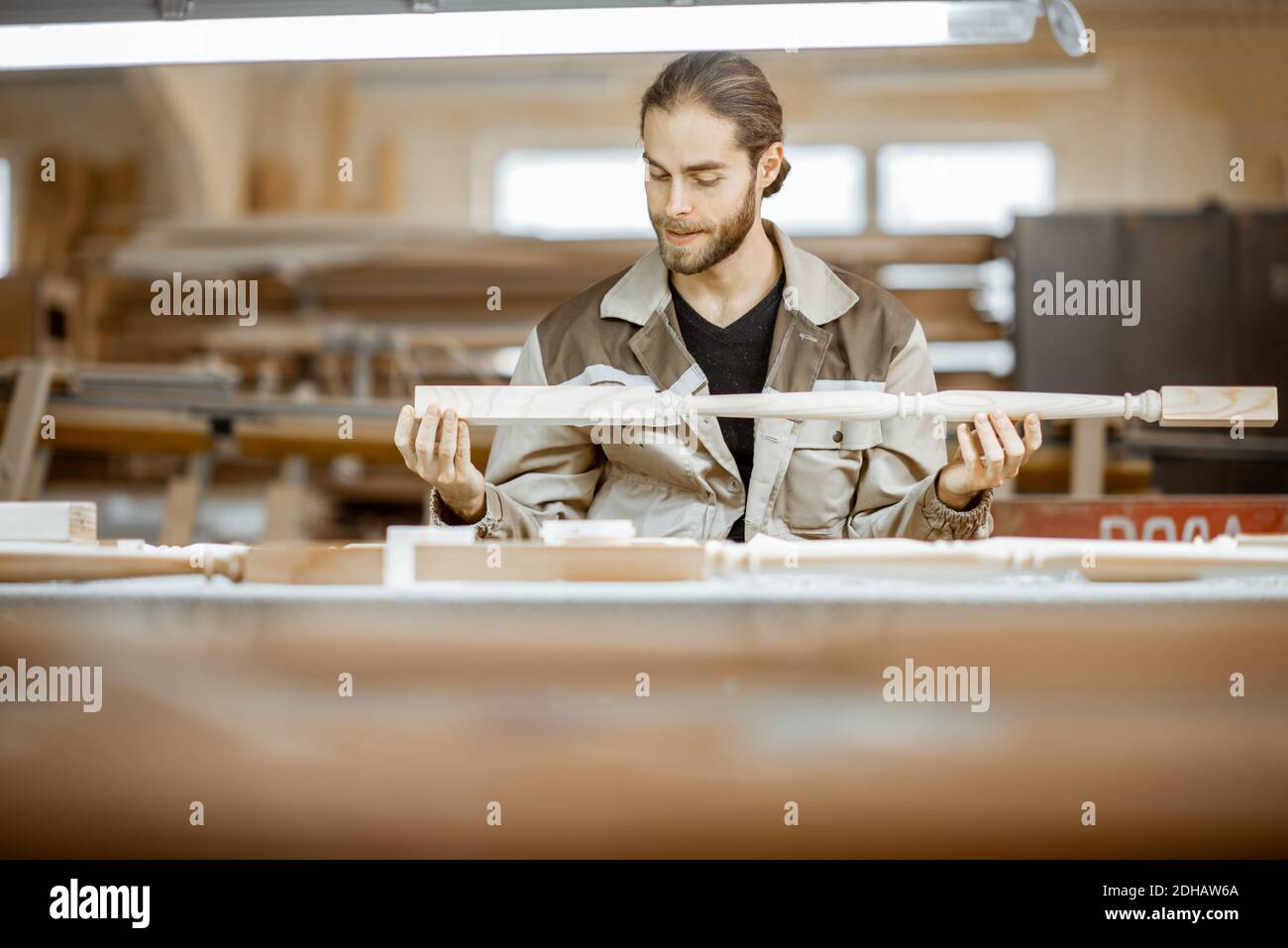 Manual worker finishing wooden products, spackling and grinding