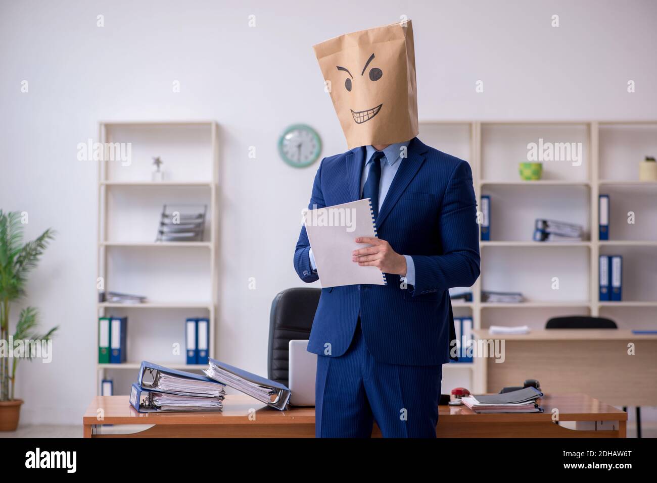 Young male employee with box instead of his head Stock Photo