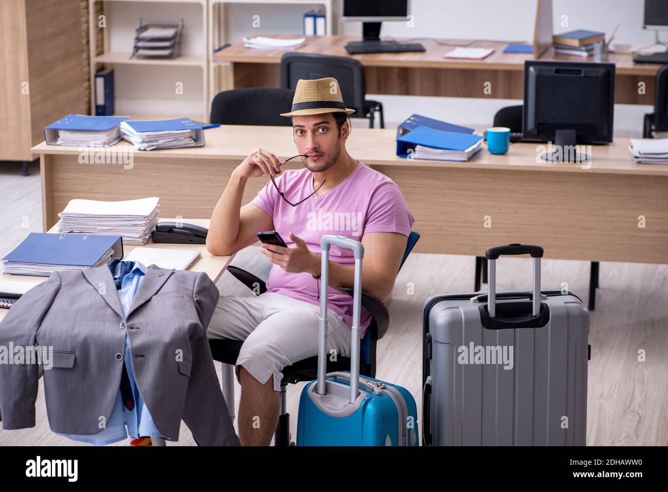 Young male employee preparing for the trip Stock Photo