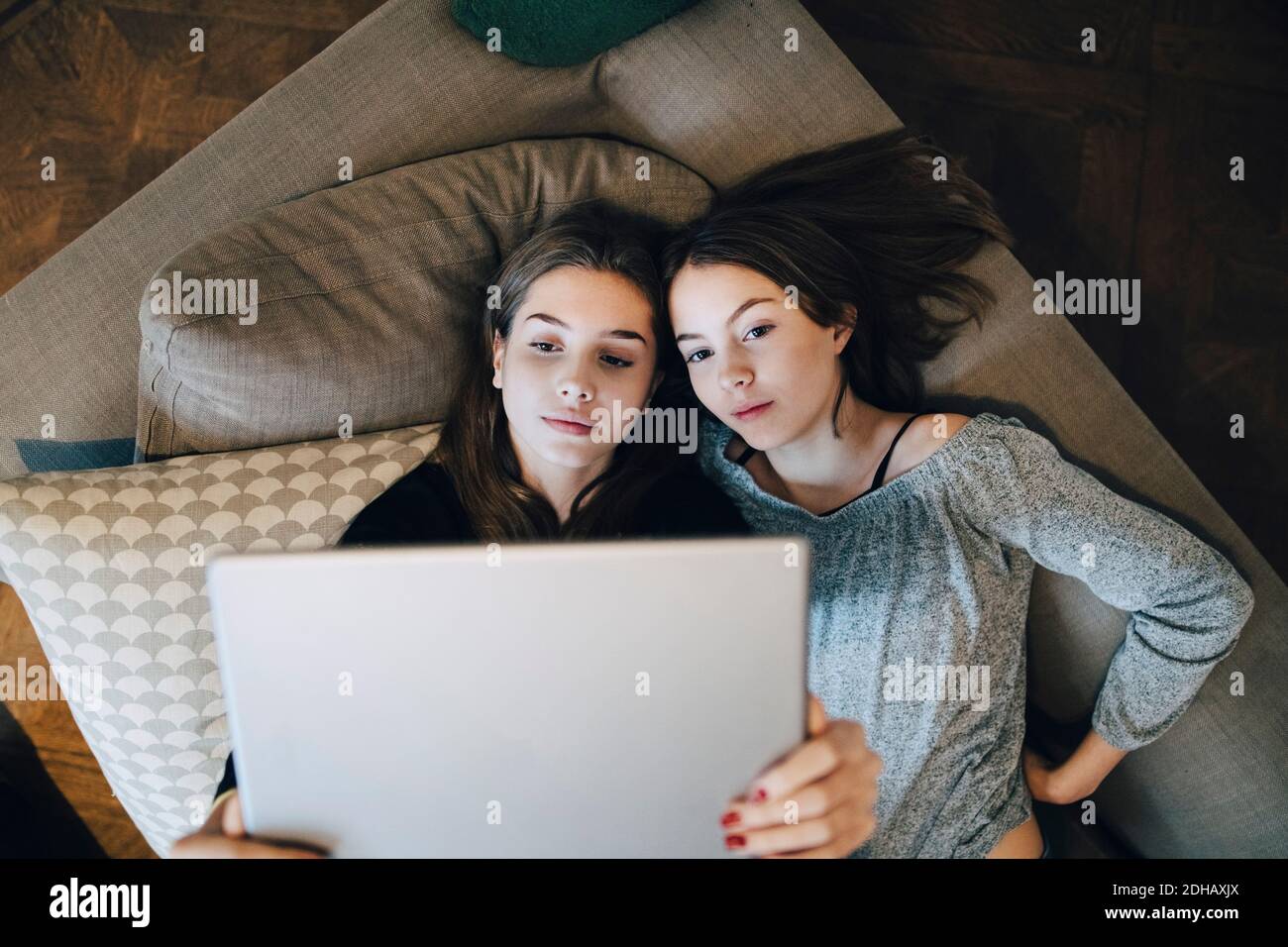 Two girls laying on sofa hi-res stock photography and images - Alamy