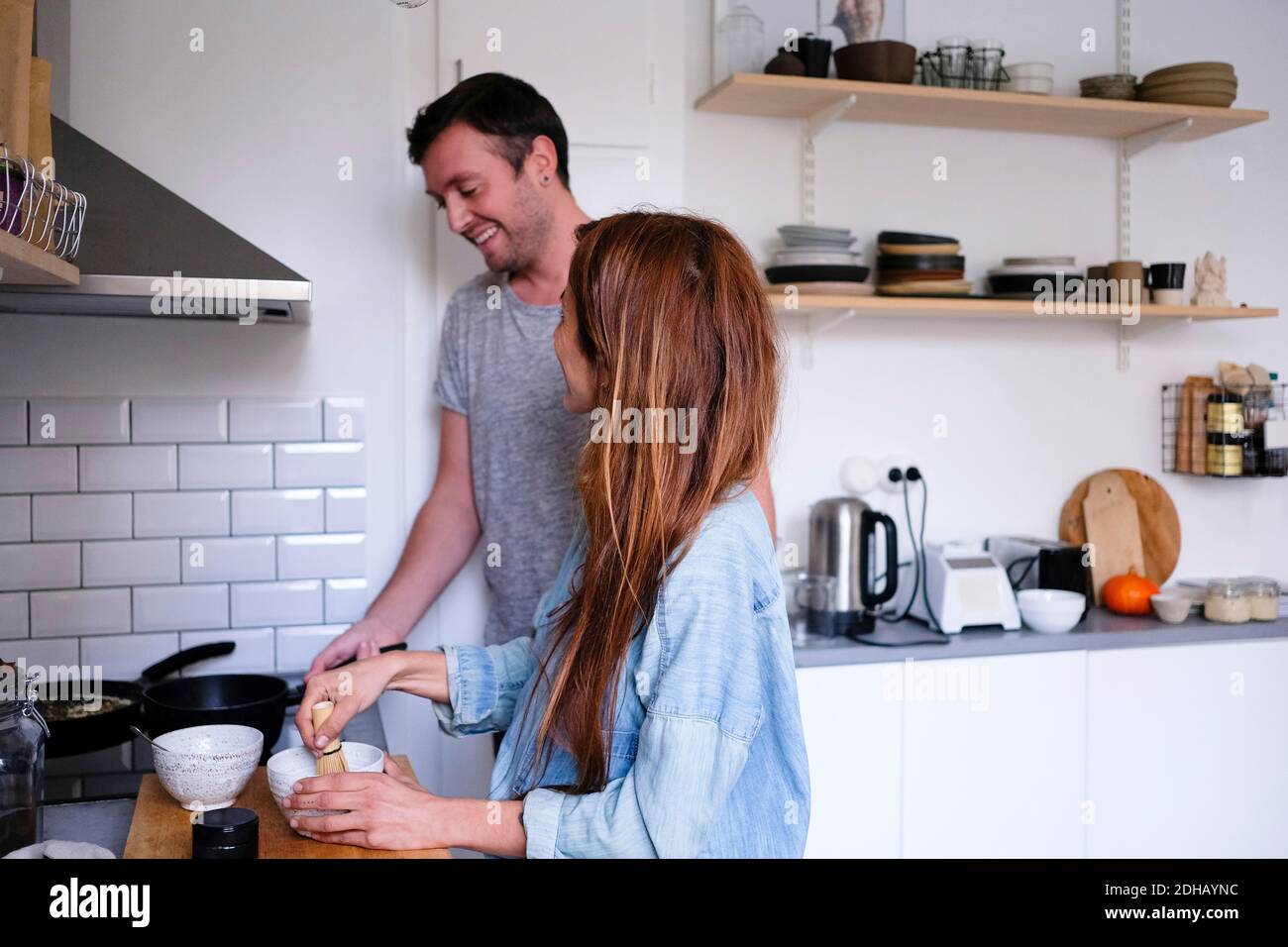 Couple home in kitchen making hi-res stock photography and images - Alamy