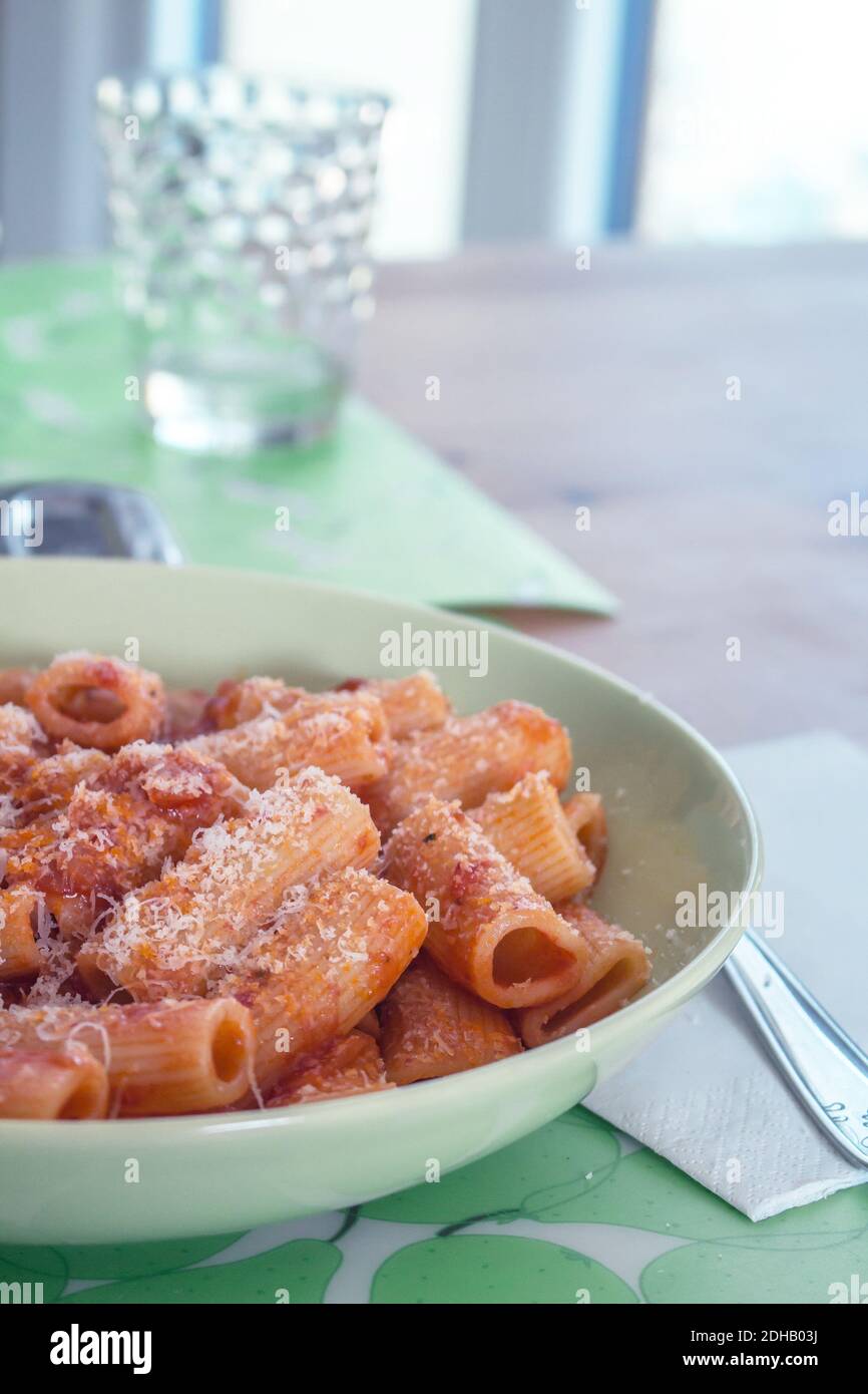 A dish of Italian cuisine: Rigatoni (a pasta shape) with tomato sauce and grated Grana Padano cheese Stock Photo