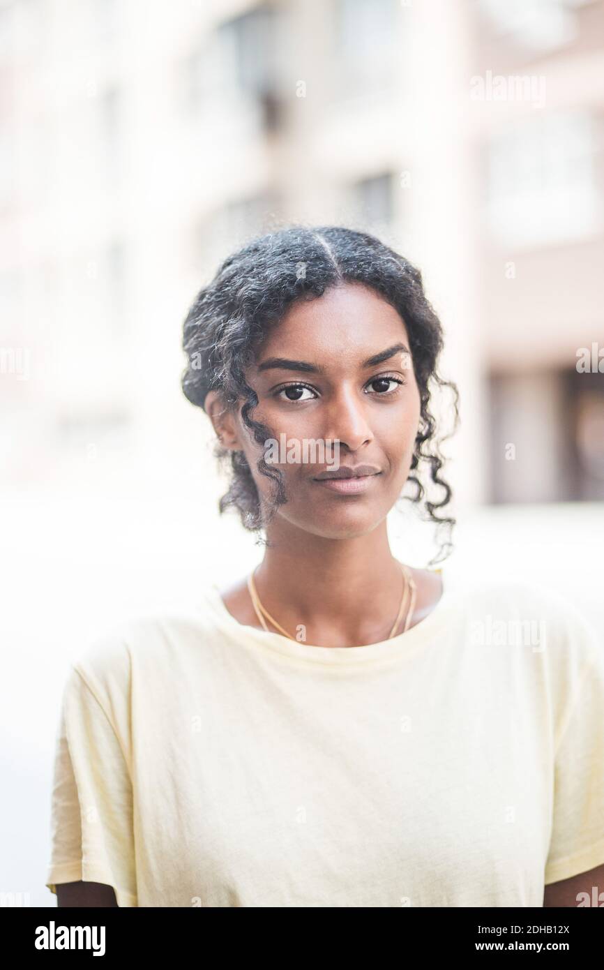 Portrait of young woman standing outdoors Stock Photo