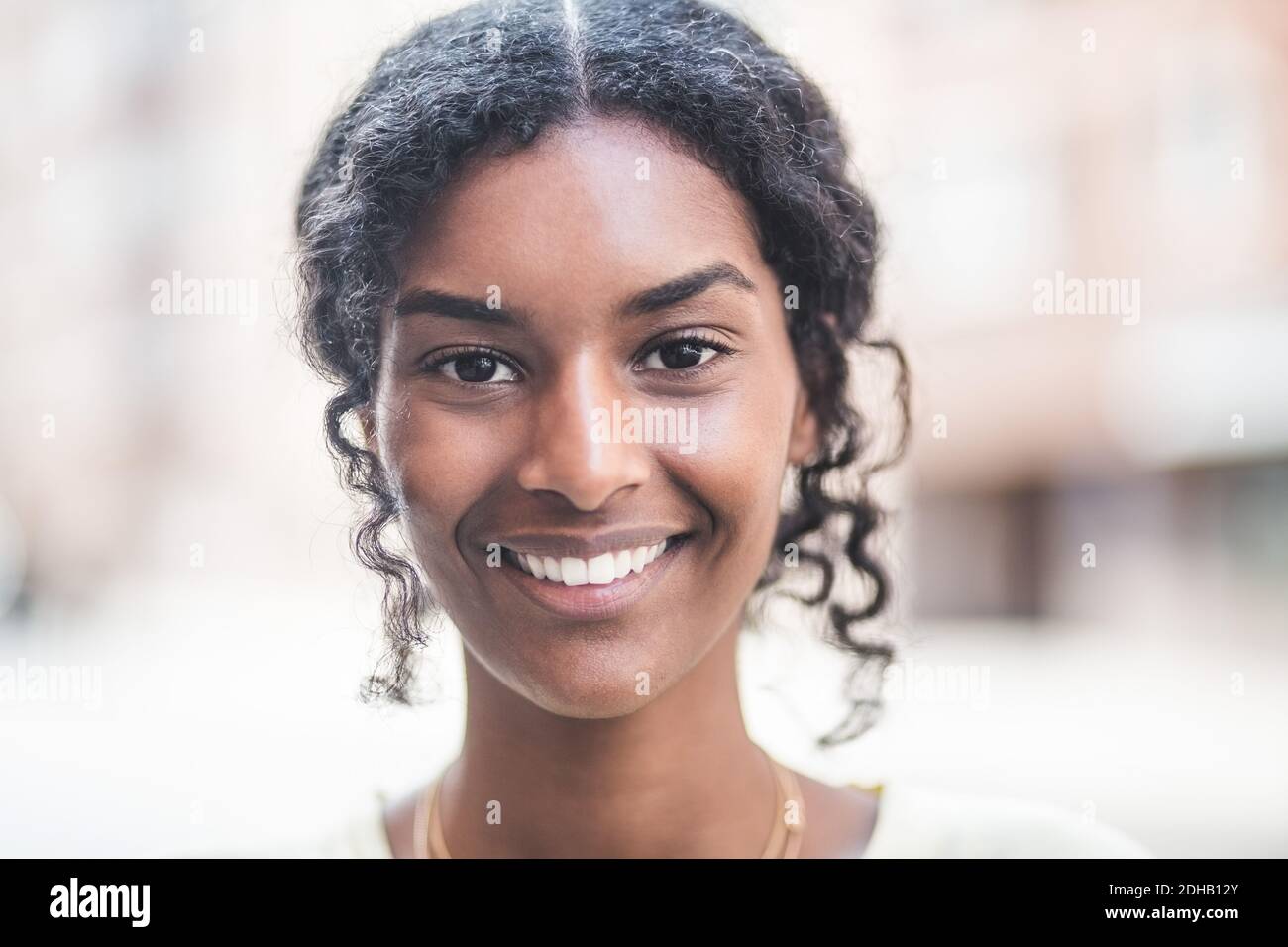 Portrait of smiling young woman in city Stock Photo