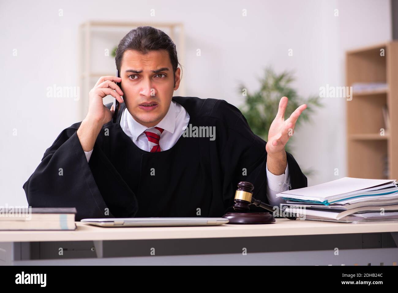 Young male lawyer working in the courthouse Stock Photo