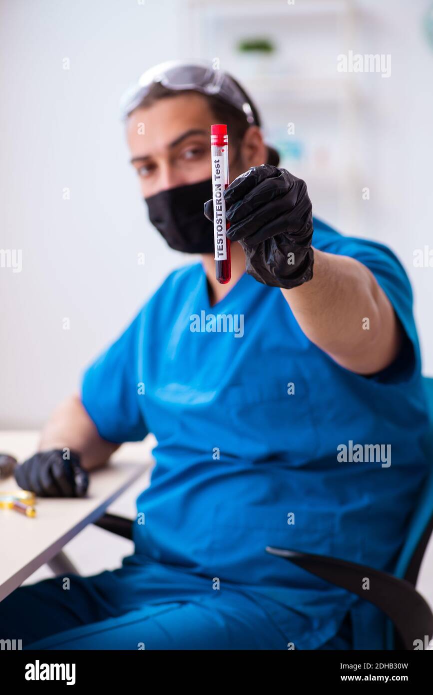 Young male biochemist testing blood samples Stock Photo