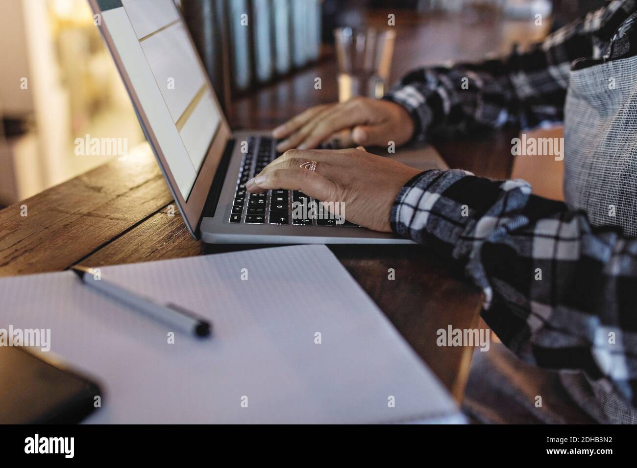 Close-up of manager using laptop at bar counter Stock Photo
