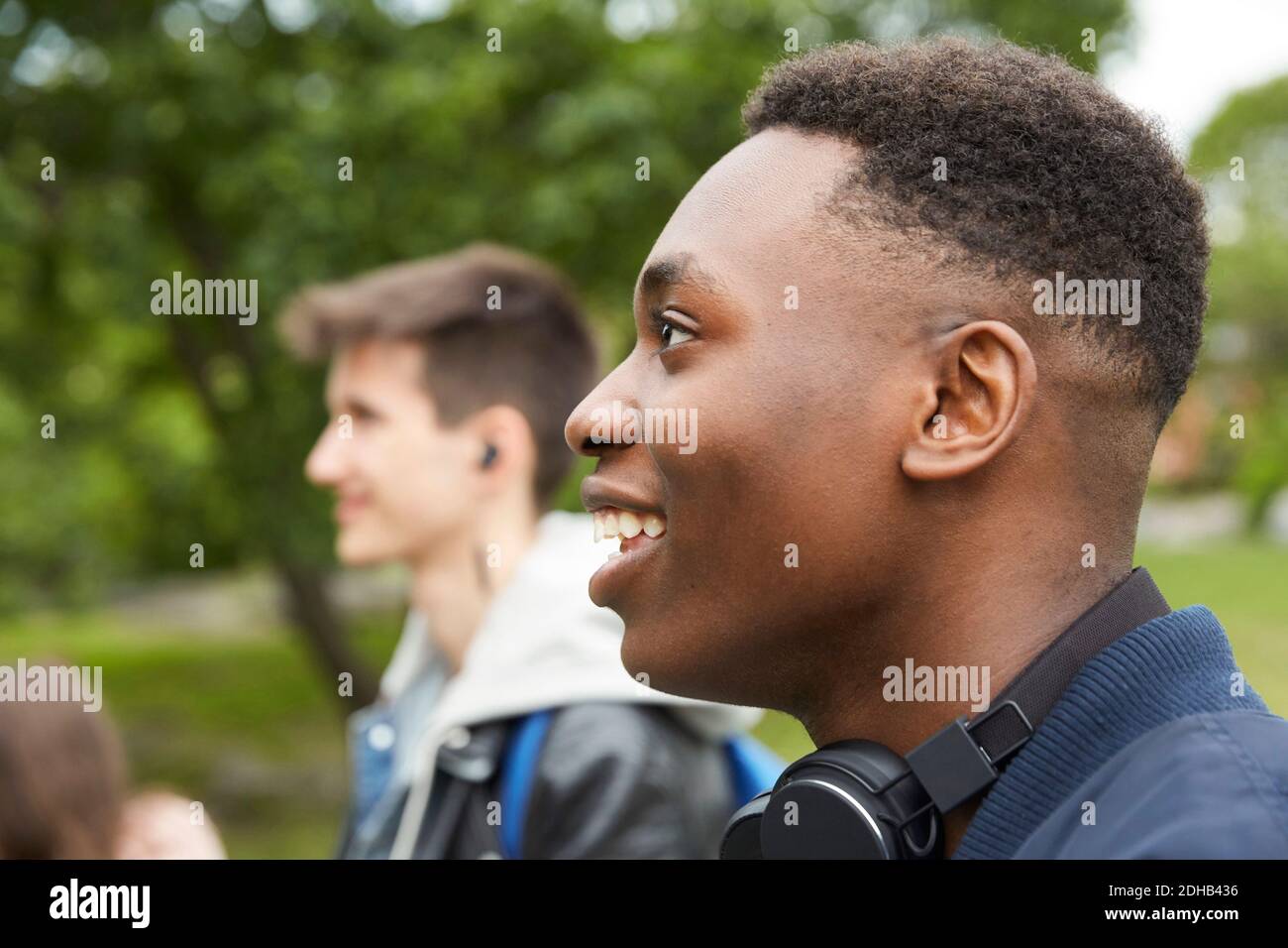 Smiling teenage boy looking away Stock Photo