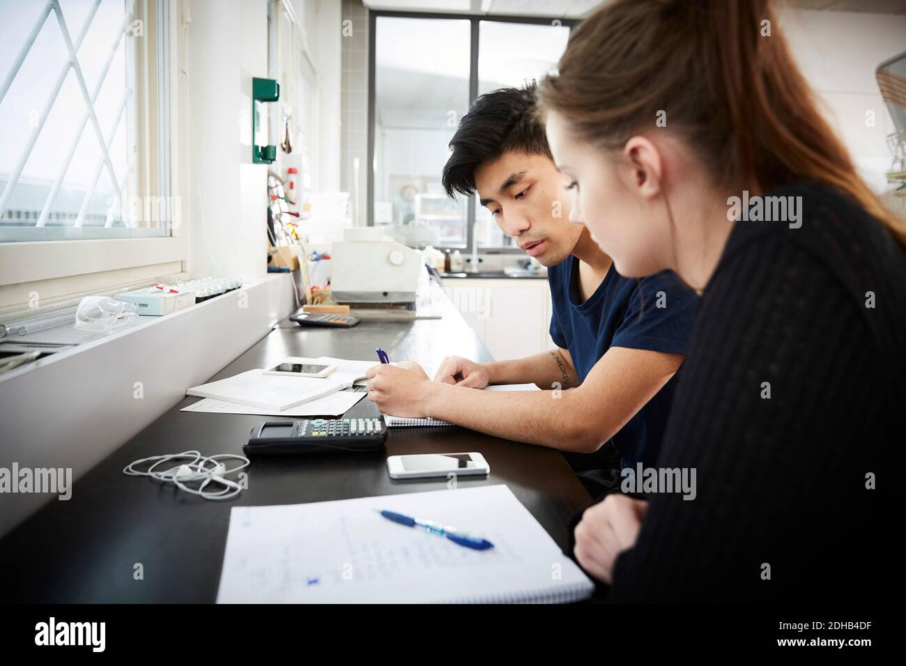 Young multi-ethnic university students studying together in classroom Stock Photo