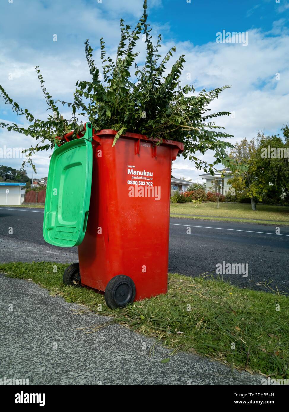 AUCKL, NEW ZEALAND - Mar 31, 2020: Auckland / New Zealand - March 29 2020: View of red Manukau garden waste bin Stock Photo