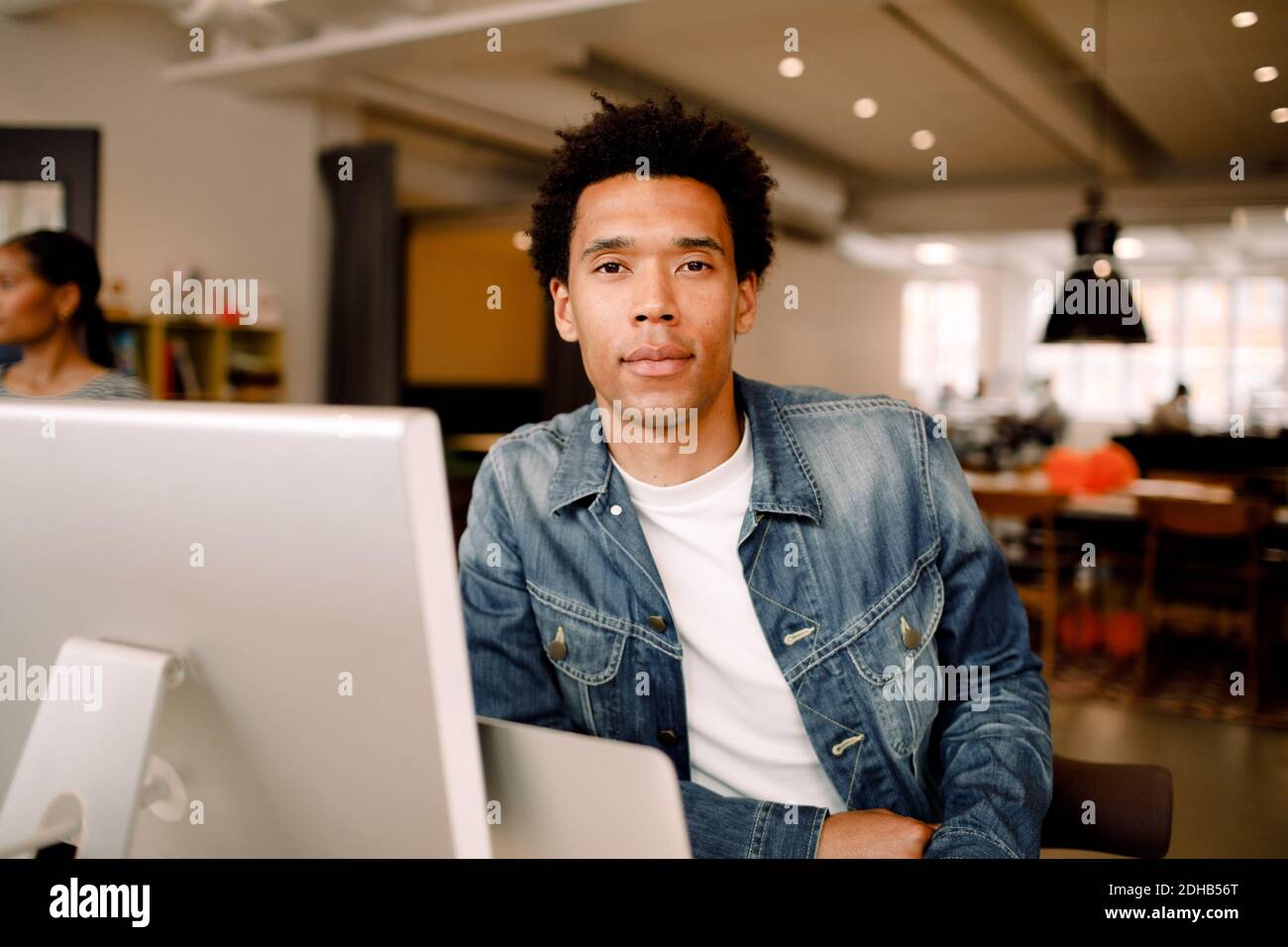 Portrait of confident young businessman sitting in office Stock Photo