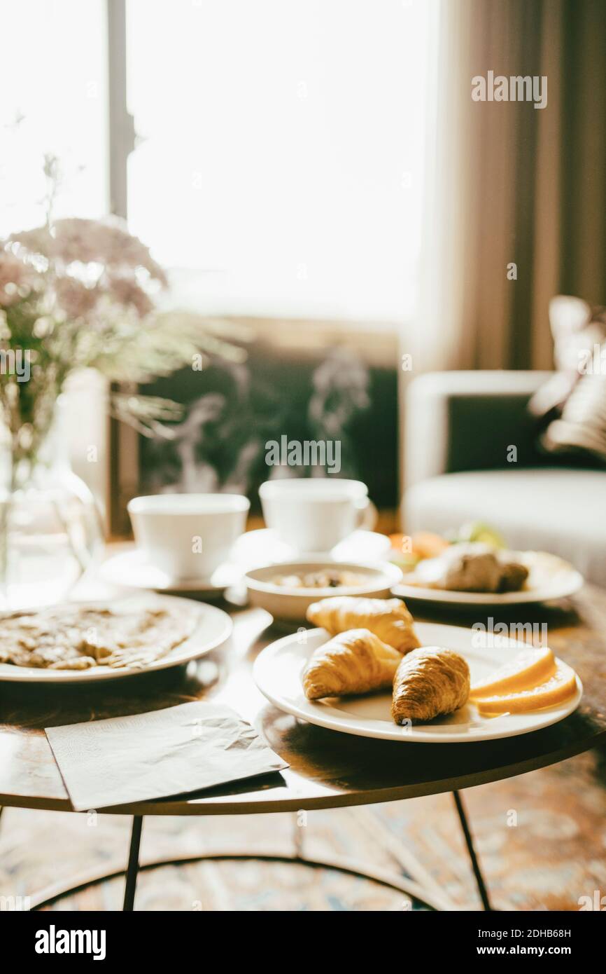 Fresh breakfast served on table in hotel room Stock Photo