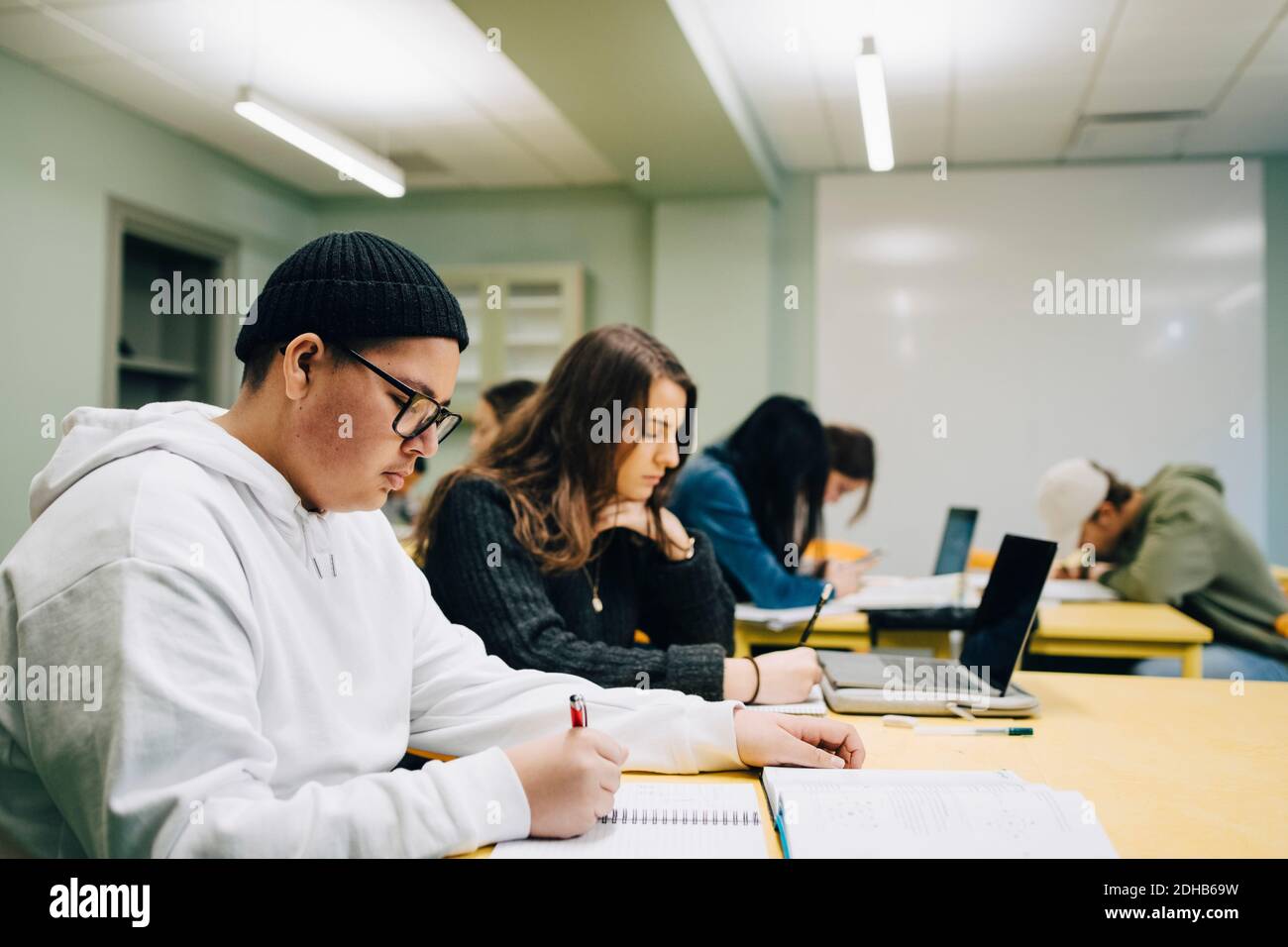 High school students studying at desk in classroom Stock Photo - Alamy
