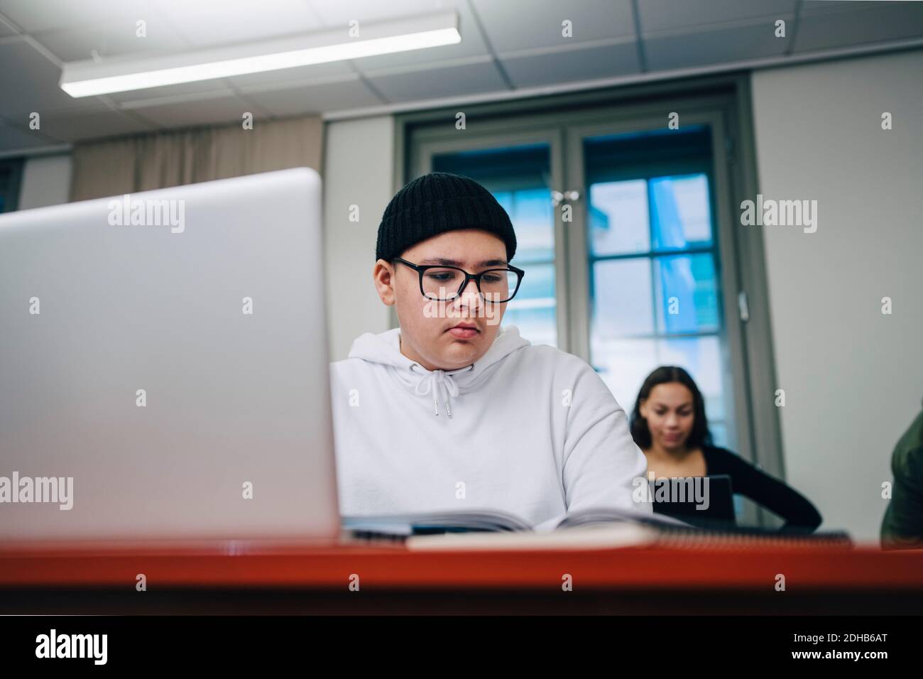 Boys using laptop at desk in school Stock Photo - Alamy