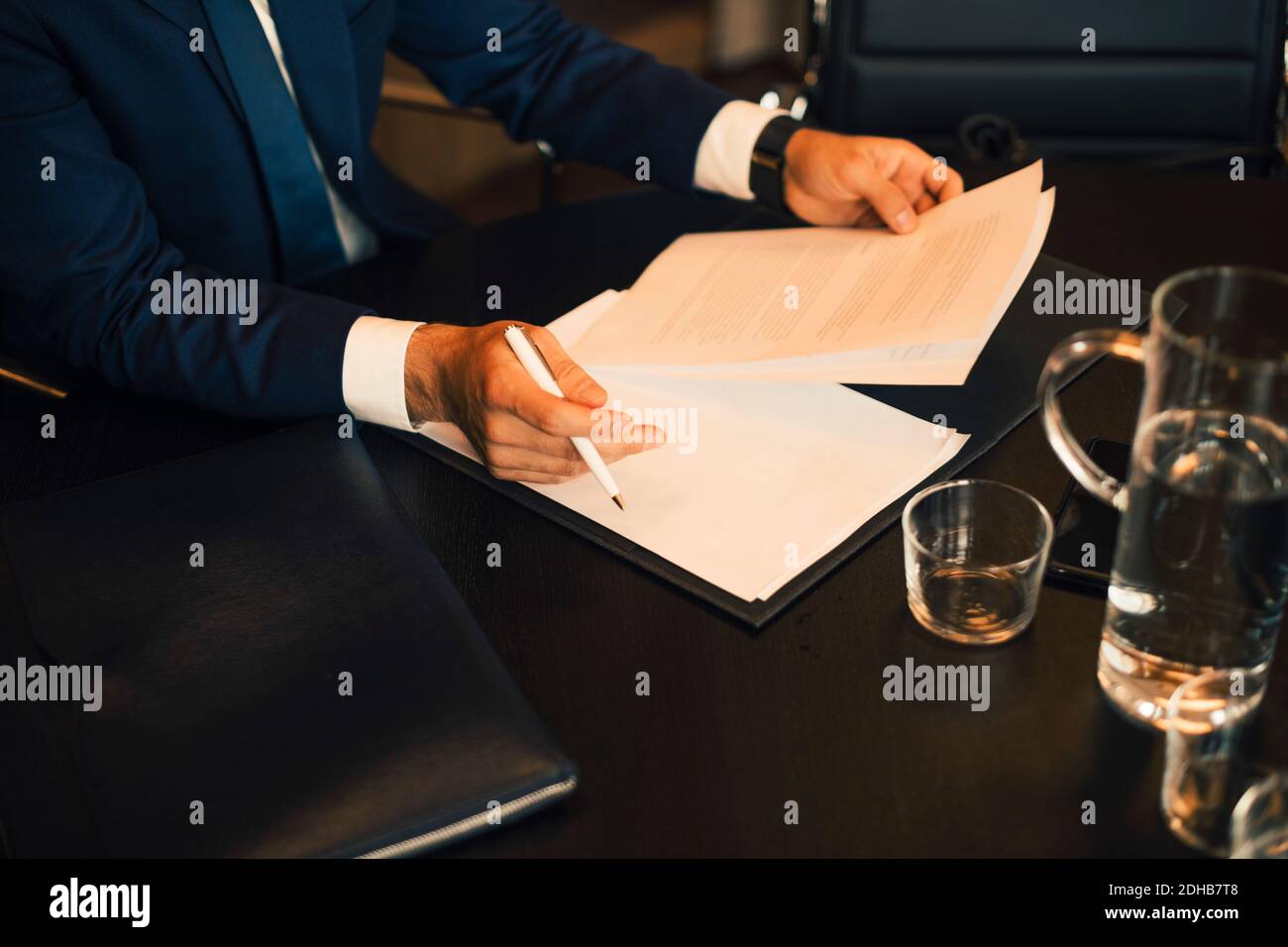 Midsection of lawyer reviewing evidence at legal office Stock Photo
